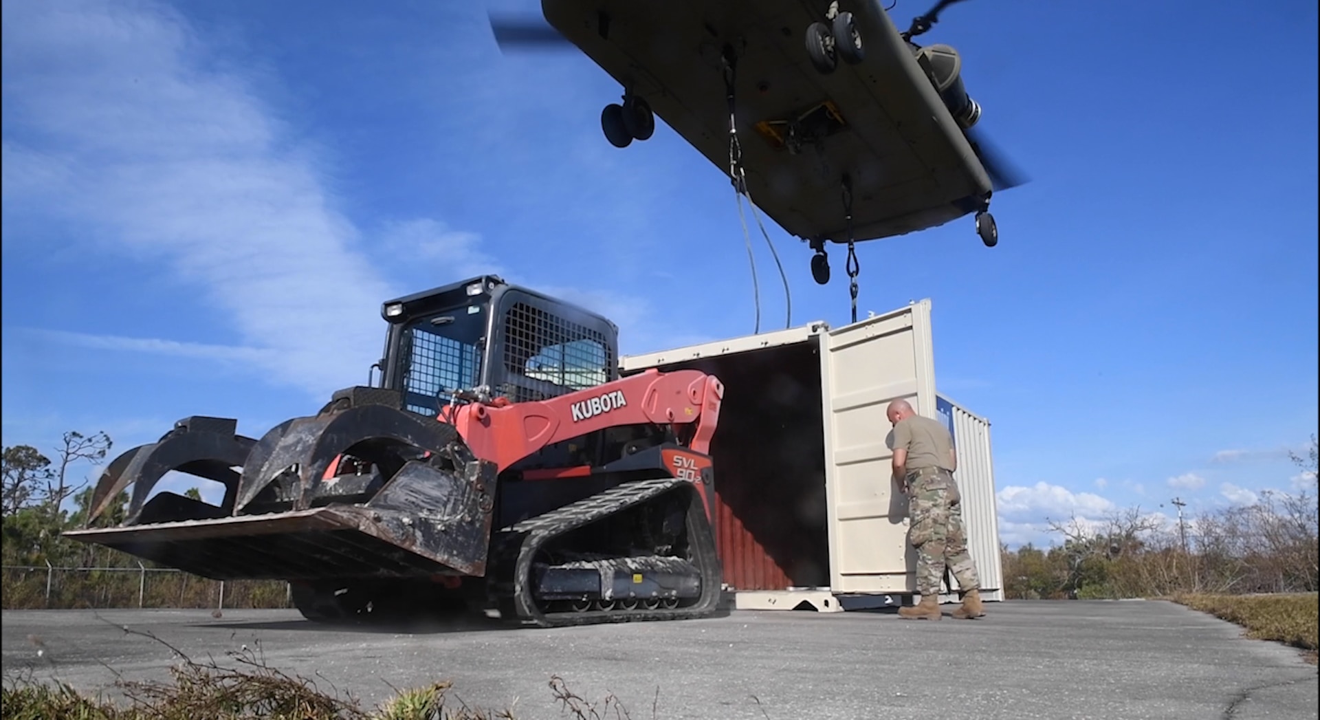 Members of the 202nd Rapid Engineer Deployable Heavy Operational Repair Squadron Engineers (RED HORSE) Squadron, Florida Air National Guard, receive equipment at St. James City, Pine Island, Florida, in response to Hurricane Ian, Oct. 3, 2022. This marks the first time in the unit's history that personnel and equipment have been airlifted into a disaster area by the Army.