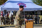 man wearing u.s. army uniform standing behind a podium