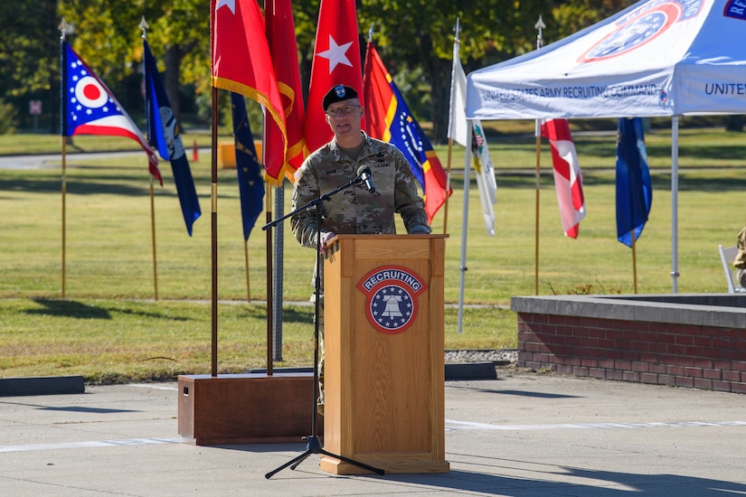 man wearing u.s. army uniform standing behind a podium