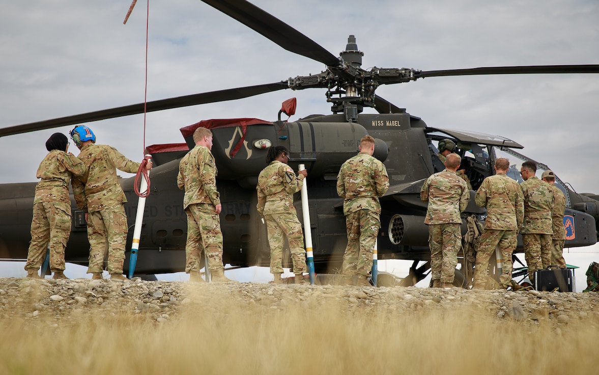 U.S. Army Soldiers assigned to the 12th Combat Aviation Brigade load training ammunition onto an AH-64D Apache Longbow helicopter in preparation for a live-fire demonstration, at the Vaziani training area in the country of Georgia, Sept. 8, 2022. Exercises like Noble Partner enable 12 CAB Soldiers to learn and grow. Noble Partner 22 builds multinational interoperability between allied and partner nations, increasing readiness and improving multinational command and control capabilities.