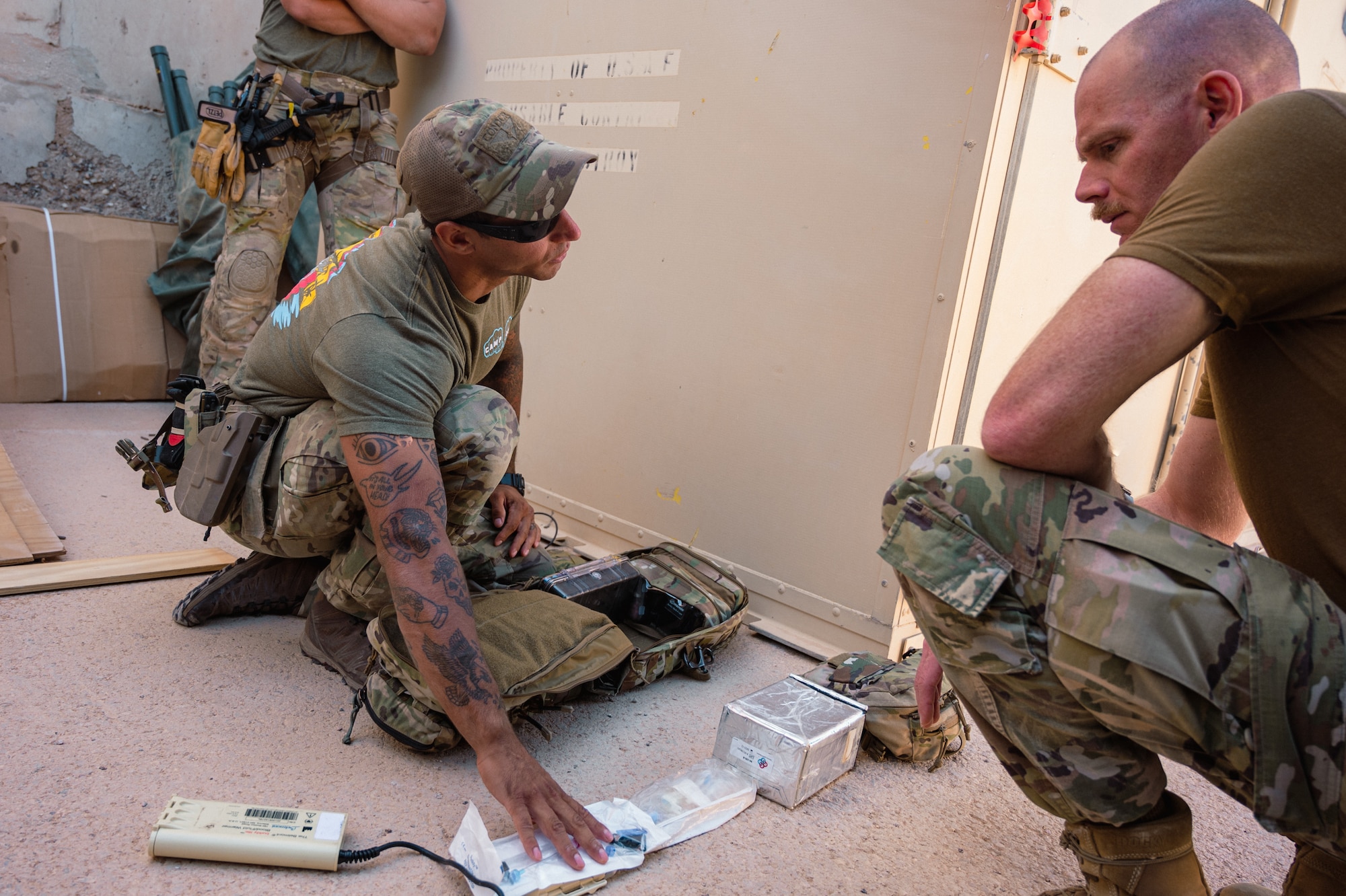 Senior Airman Vijay Anderson, Pararescue Jumper assigned to the 52nd Expeditionary Rescue Squadron, discusses lifesaving interventions and trauma casualty care with U.S. Air Force Col. Jason Houston, Deputy Commander, 332d Air Expeditionary Wing, as part of the “Red Tail Connection” program at an undisclosed location, September 28, 2022. These immersion visits provide greater insight into the unique skillsets every Airman brings to the 332d AEW Red Tail team. (U.S. Air Force photo by Tech. Sgt. Richard Mekkri)