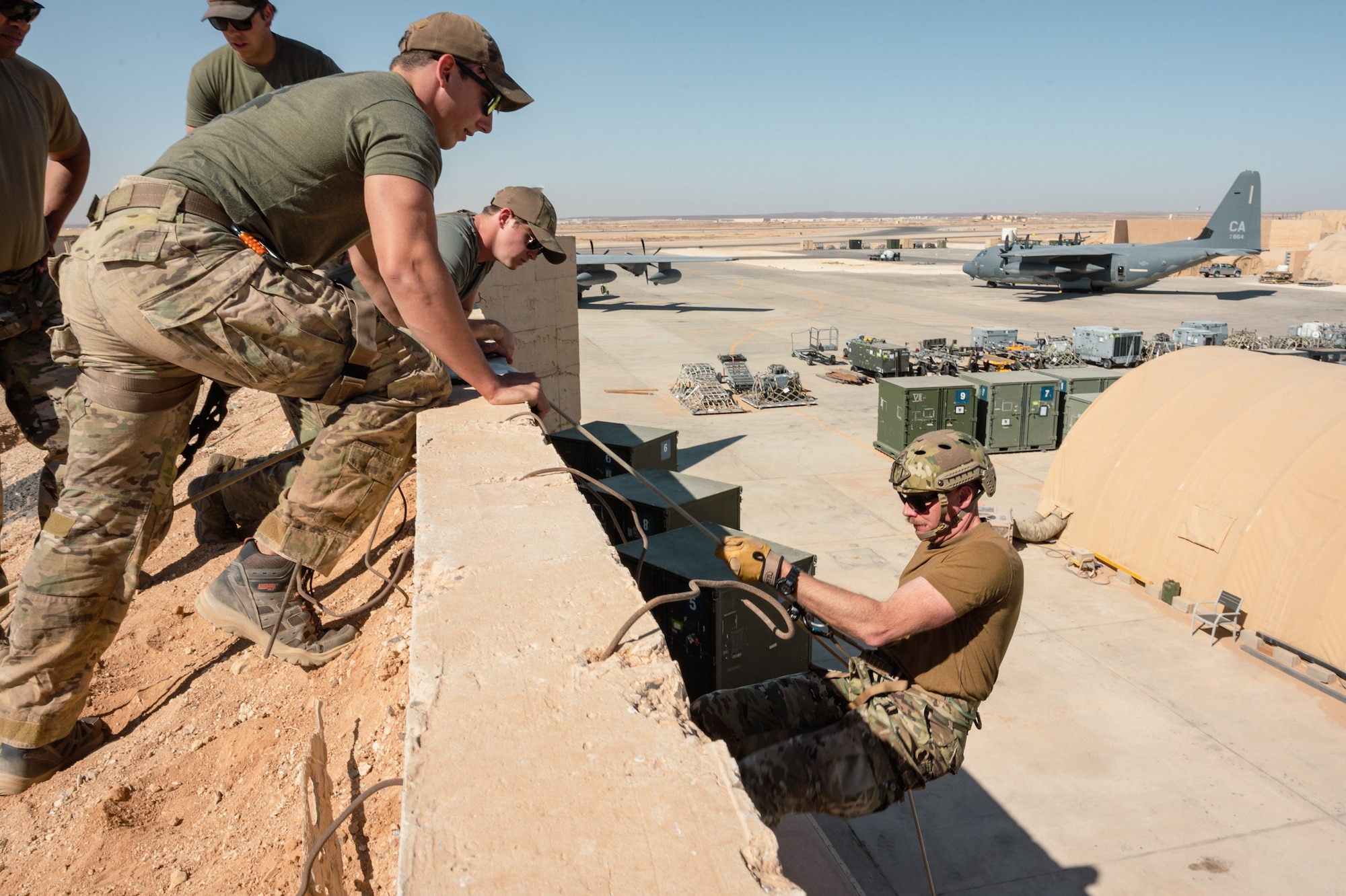 U.S. Air Force Personnel Recovery Task Force member Senior Airman Josiah Turdick, Safety Man assigned to the 52nd Expeditionary Rescue Squadron, instructs U.S. Air Force Col. Jason Houston, Deputy Wing Commander, 332d Air Expeditionary Wing, on an anchor line system for a technical rescue and rappel operation, as part of the “Red Tail Connection” program at an undisclosed location, September 28, 2022. These immersion visits provide greater insight into the unique skillsets every Airman brings to the 332d AEW Red Tail team. (U.S. Air Force photo by Tech. Sgt. Richard Mekkri)
