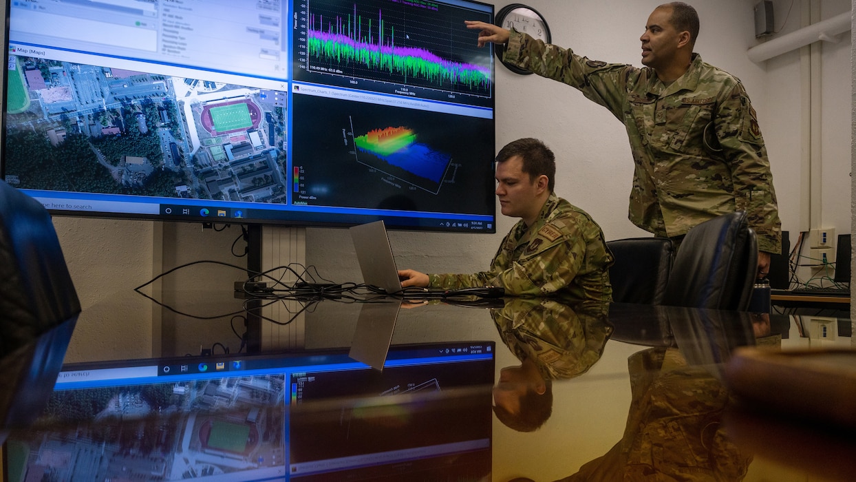 U.S. Air Force Tech. Sgt. Ricardo Hernandez, 1st Communications Maintenance Squadron network operations section chief, left, and Tech. Sgt. Chad Fisher, 1st CMXS unit training manager, discuss electromagnetic spectrum operations at Kapaun Air Station, Germany, April 5, 2022. In addition to providing traditional communications maintenance mission sets, the 1st CMXS enables warfighters to accomplish the 435th Air Ground Operation Wing’s Inside Out mission to get payloads on time, every time. (U.S. Air Force photo by Senior Airman John R. Wright)