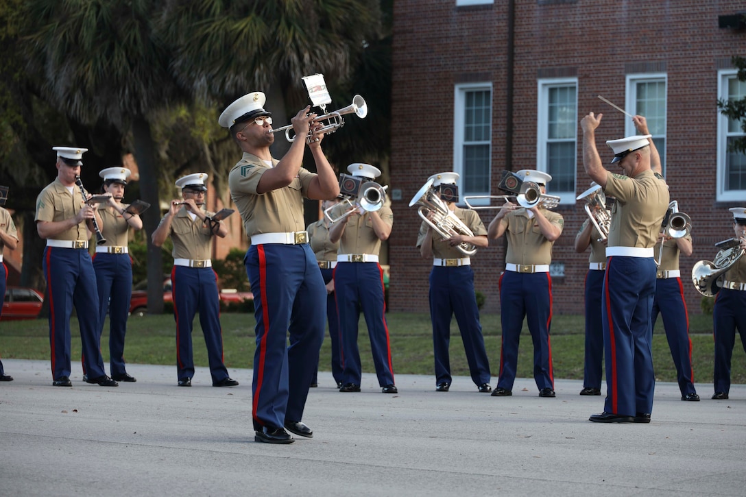 A U.S. Marine with the Parris Island Marine Band plays a trumpet solo during a colors ceremony at Marine Corps Recruit Depot Parris Island, South Carolina, April 7, 2022. The sergeant major of the Marine Corps and his spouse, retired First Sgt. Stacie Black were the parade reviewing officials for Lima Company graduation ceremony. Marine Corps Recruit Depot Parris Island has transformed young men and women into Marines since 1915. (U.S. Marine Corps photo by Staff Sgt. Victoria Ross)