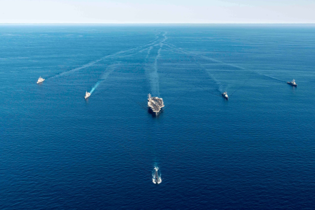 Six ships sail in formation.