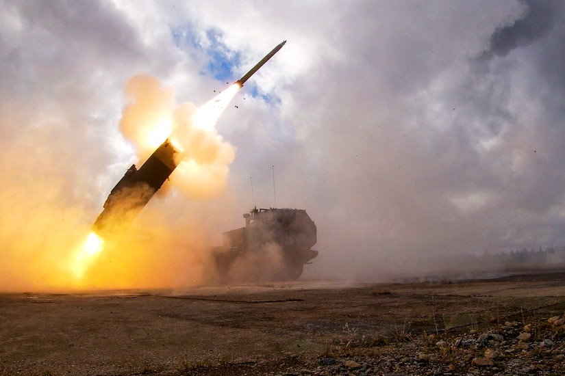 A military vehicle fires a rocket into the sky.
