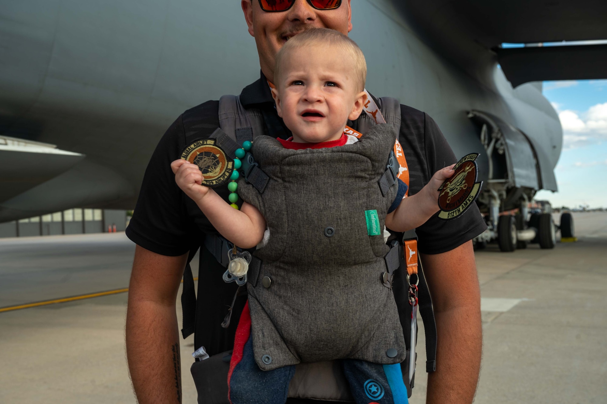A child holds patches from the 512th Airlift Wing at an outreach event at Peterson Space Force Base, Colorado, Sept. 30, 2022. During the outreach event, the Team Dover total force aircrew gave tours to more than 175 cadets from the United States Air Force Academy, USAFA Preparatory School and their family members. (U.S. Air Force photo by Senior Airman Faith Barron)