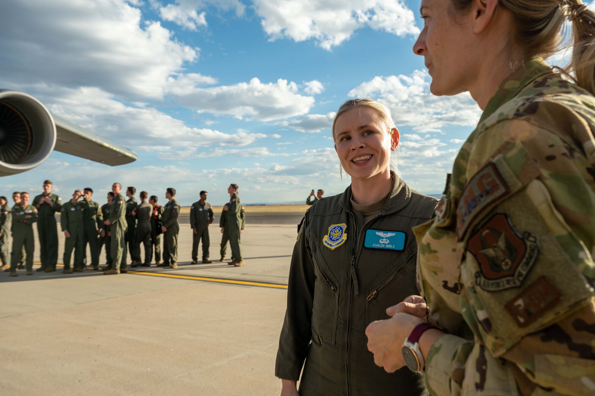 Capt. Ashlen Bible, left, 9th Airlift Squadron aircraft commander, speaks with Staff Sgt. Stephanie Garber, 709th Airlift Squadron flight engineer, before giving a tour of the C-5M Super Galaxy to United States Air Force Academy cadets at Peterson Space Force Base, Colorado, Sept. 30, 2022. During the outreach event, the Team Dover total force aircrew gave tours to more than 175 cadets from USAFA, USAFA Preparatory School and their family members. (U.S. Air Force photo by Senior Airman Faith Barron)