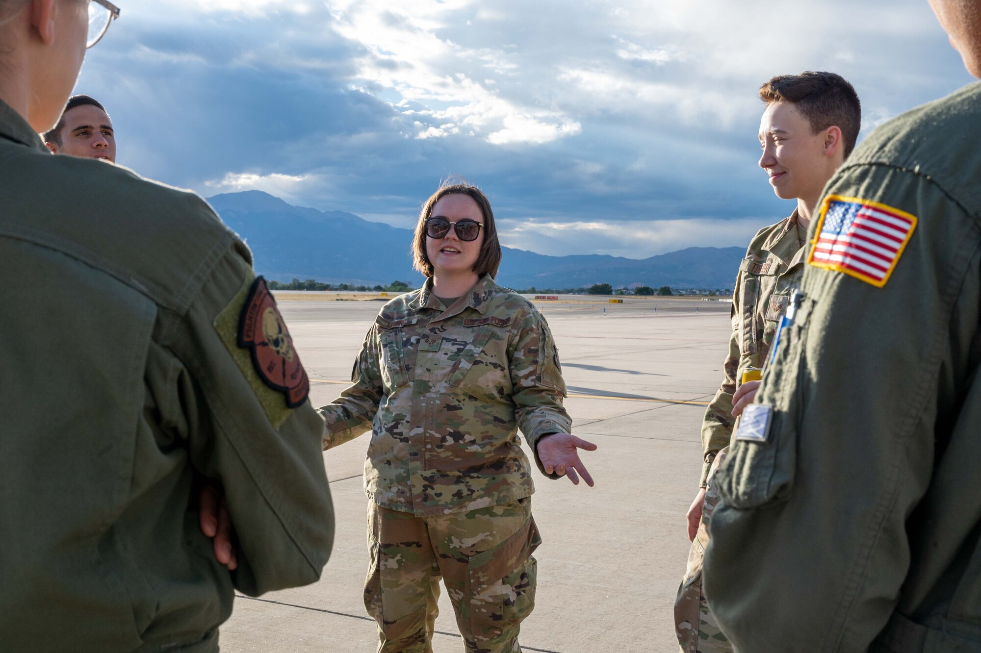 Senior Airman Cortnee Madrid, 436th Aircraft Maintenance Squadron crew chief, talks to cadets from the United States Air Force Academy during an outreach event at Peterson Space Force Base, Colorado, Sept. 30, 2022. During the event, the aircrew was able to brief over 175 cadets on science, technology, engineering and mathematics career field opportunities in the U.S. Air Force. (U.S. Air Force photo by Senior Airman Faith Barron)