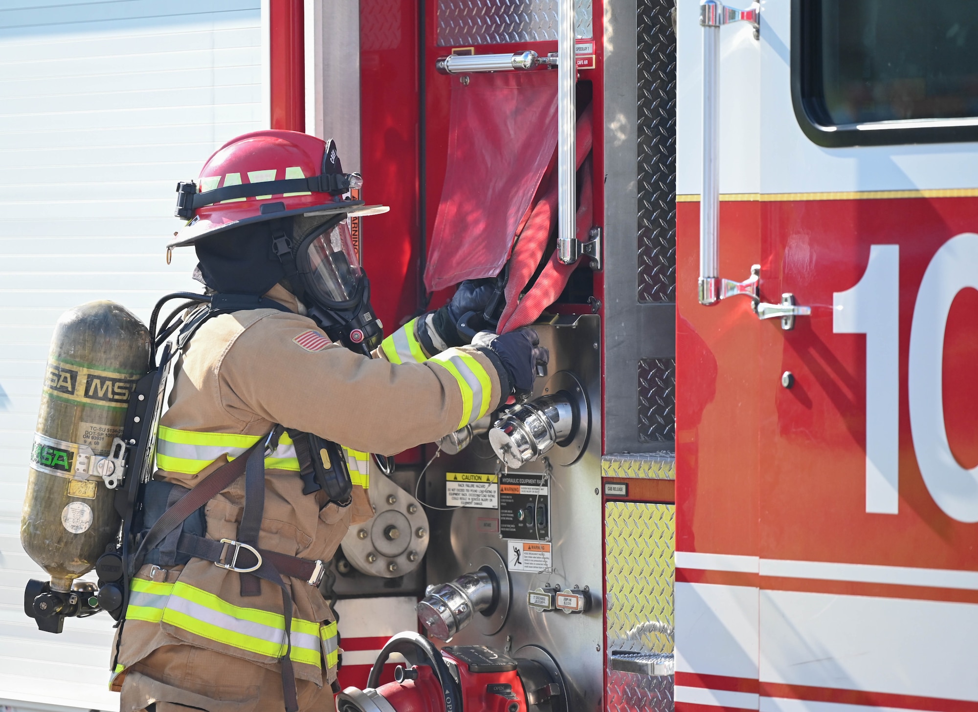 a man advances a fire hose