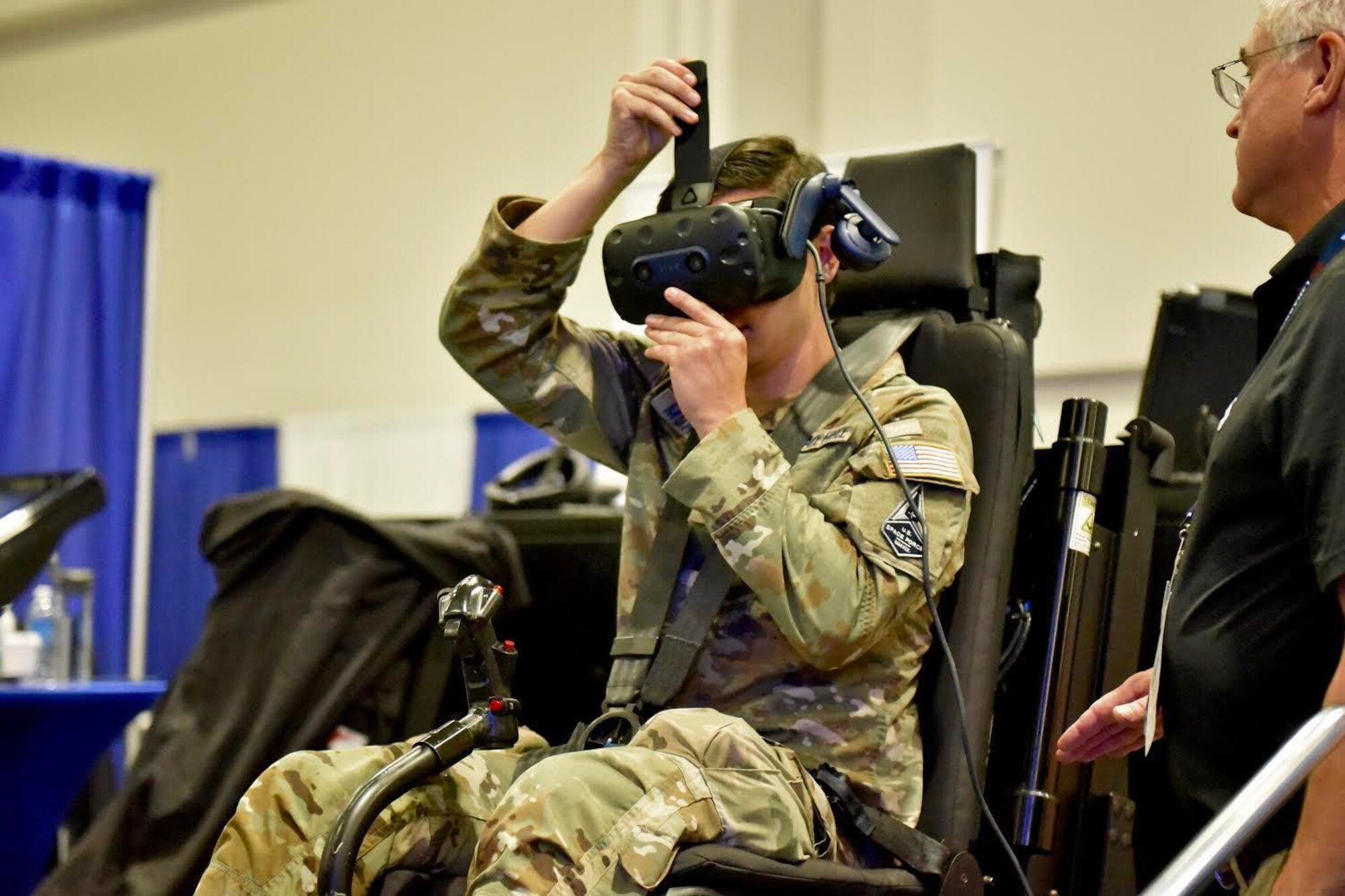 U.S. Air Force 1st Lt. Aaron Morales, 16th Electronic Warfare Squadron data engineer, pilots a helicopter virtual-reality simulator at a booth during the Air, Space & Cyber Conference in Washington D.C., Sept. 21, 2022. Members from the 350th SWW had the opportunity to hear key leaders speak on panels and interact with vendors in the exhibit hall to learn more about capabilities being offered to the U.S. Air Force. (U.S. Air Force photo by 1st Lt Benjamin Aronson)