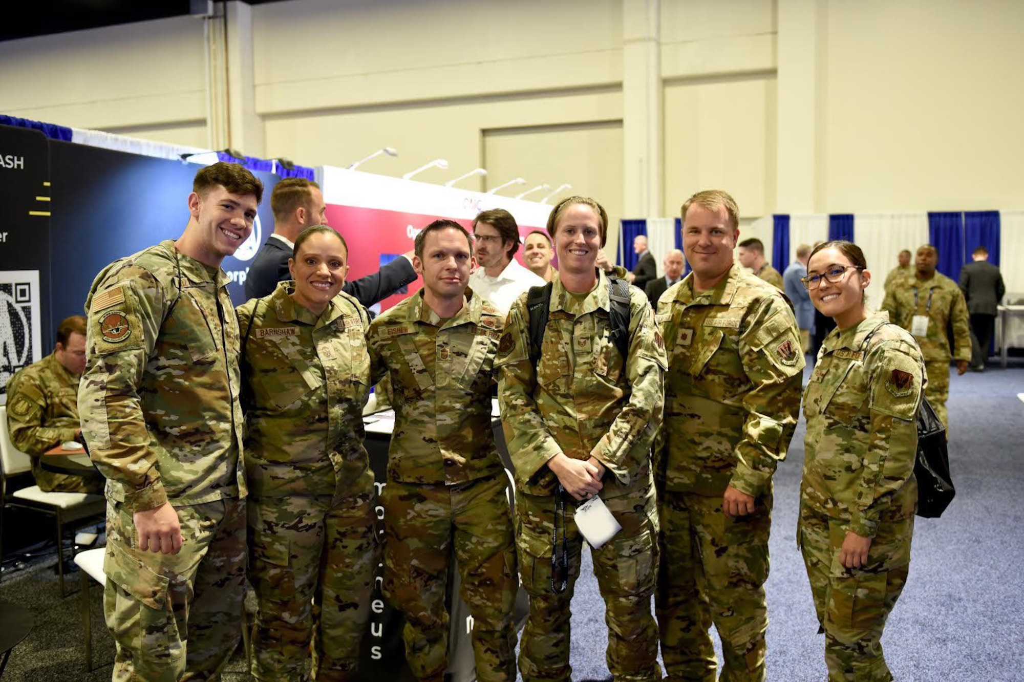 Members from the 350th Spectrum Warfare Wing pose for a photo with U.S. Air Force Chief Master Sgt. Ian Eishen, Chief of Staff of the Air Force Strategic Studies Group senior enlisted leader, at the Air, Space & Cyber Conference in Washington D.C., Sept. 19, 2022. Members from the 350th SWW had the opportunity to hear key leaders speak on panels and interact with vendors in the exhibit hall to learn more about capabilities being offered to the U.S. Air Force. (U.S. Air Force photo by 1st Lt Benjamin Aronson) (This photo has been altered for security purposes by blurring
out identification badges.)