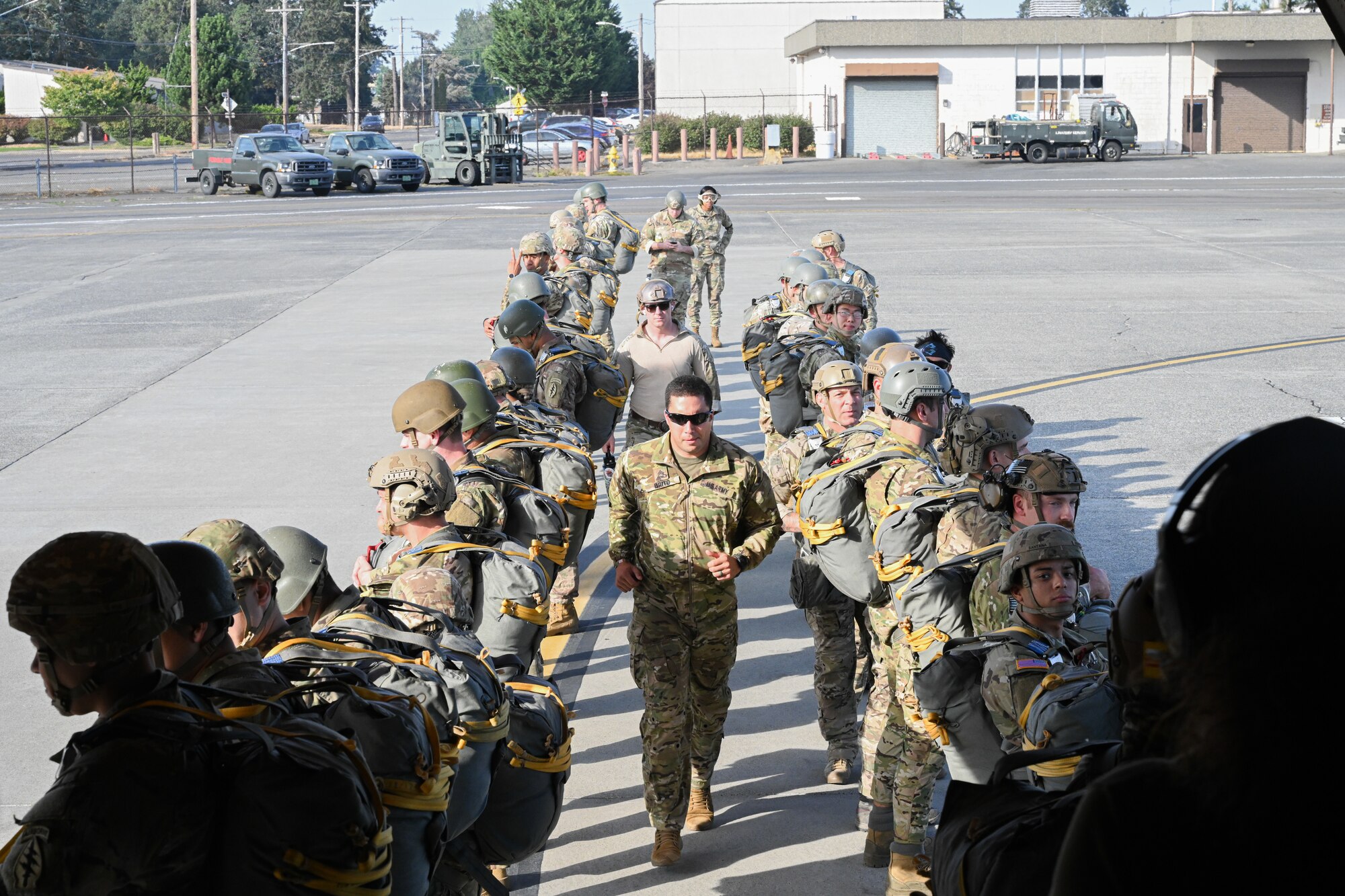 Paratroopers board on a plane.