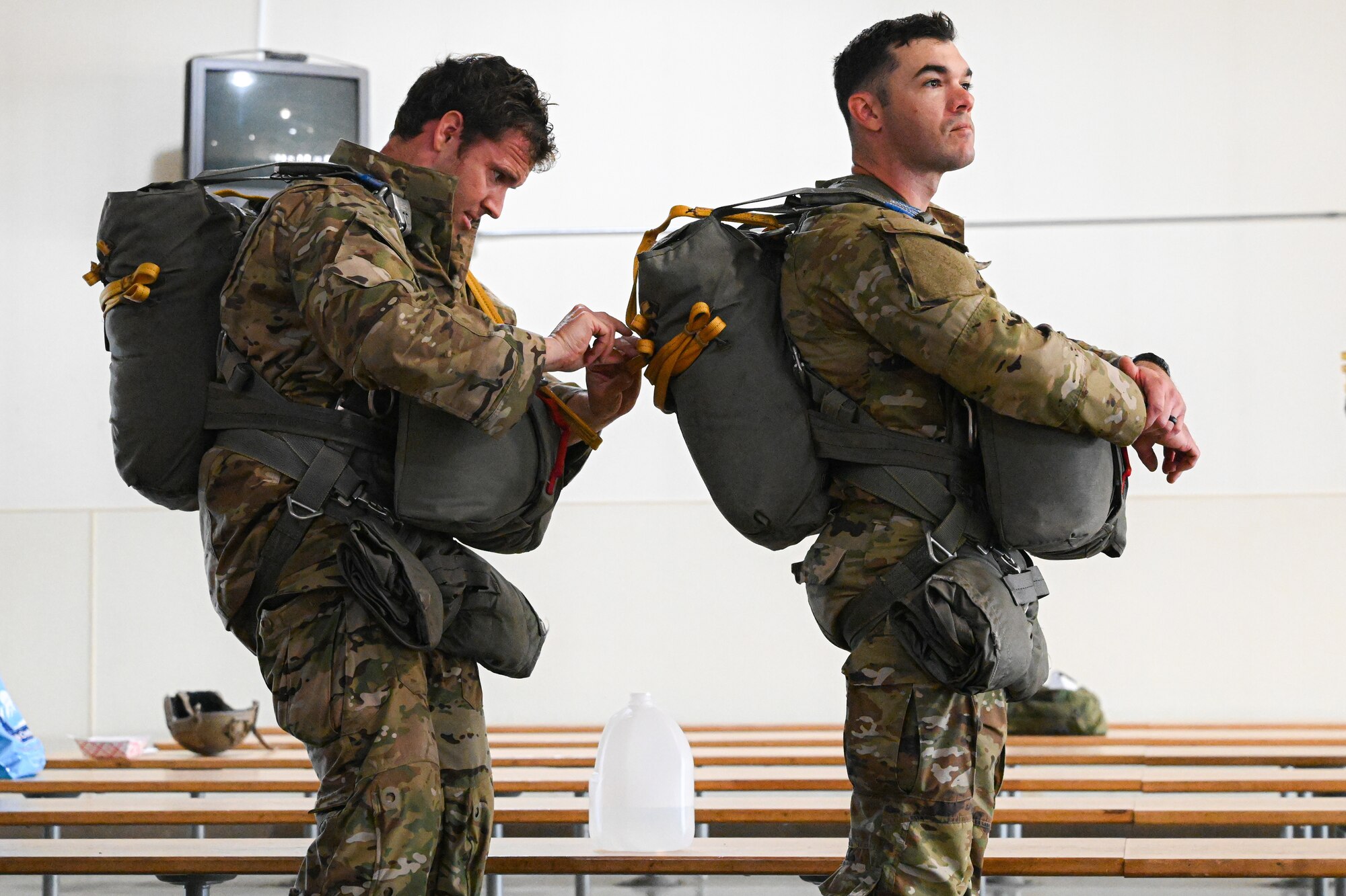 Paratroopers get their equipment ready before boarding on a plane.