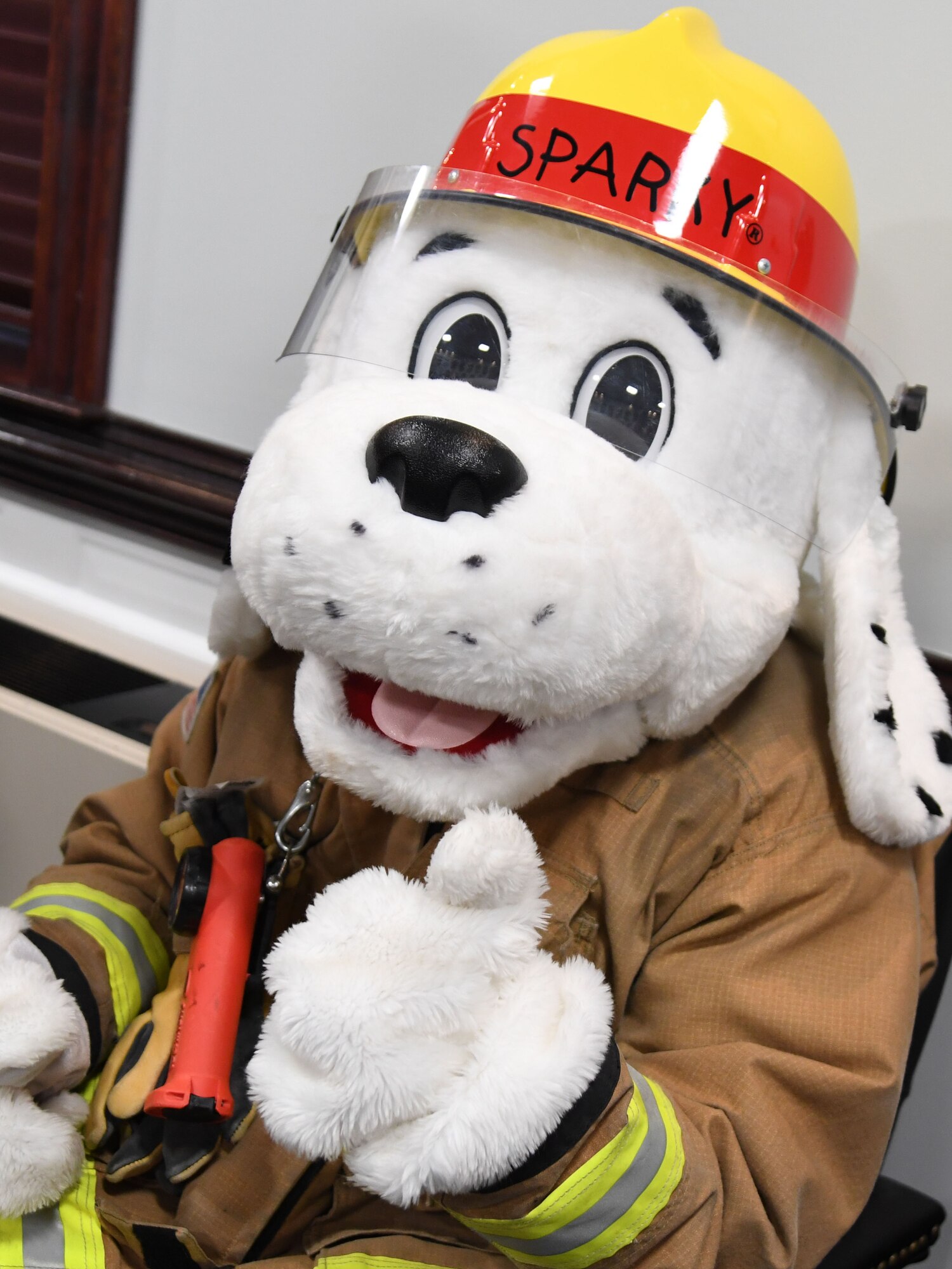 Sparky poses for a photo during the Fire Prevention Week proclamation signing inside the 81st TRW headquarters building at Keesler Air Force Base, Mississippi, Oct. 4, 2022. The week-long event, Oct. 9-15, includes fire drills, literature hand-outs and visits from Sparky around the base. (U.S. Air Force photo by Kemberly Groue)