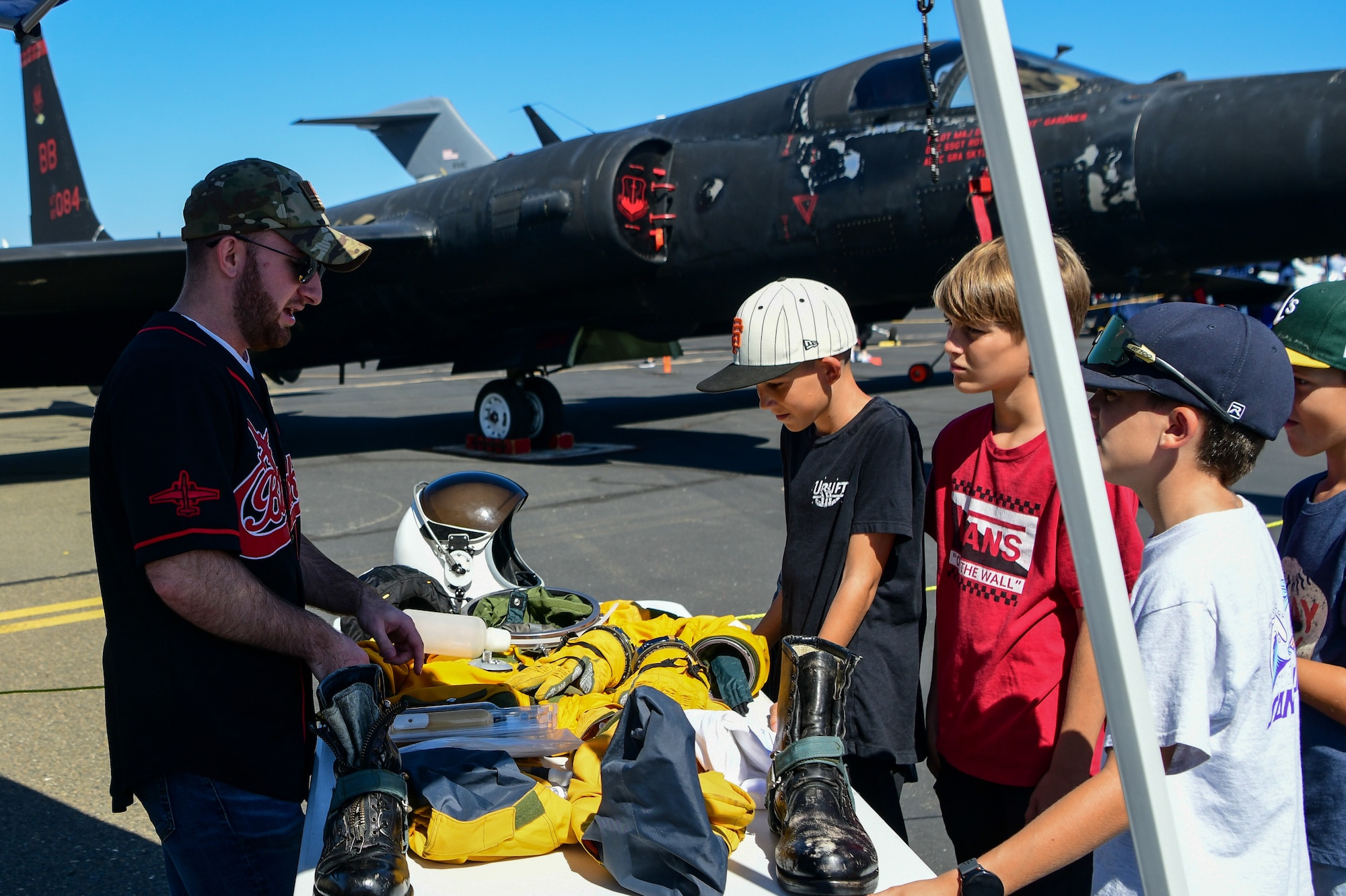 A group of children look at the U-2 flight suit display during the California Capital Airshow at Mather Airport, Calif., on Oct. 2, 2022.