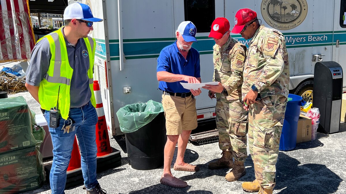 Members of the 202nd Rapid Engineer Deployable Heavy Operational Repair Squadron Engineers Squadron, Florida Air National Guard, look at a map prior to clearing roads in Fort Myers Beach, Fla. in response to Hurricane Ian, Sept. 30, 2022. The 202nd RED HORSE Squadron, stationed at Camp Blanding, Fla., is a specialized, highly mobile civil engineering team comprised of Florida Air National Guardsmen that provides rapid response capabilities for multiple worldwide contingencies and operations. (U.S. Air National Guard photo by Senior Airman Jacob Hancock)