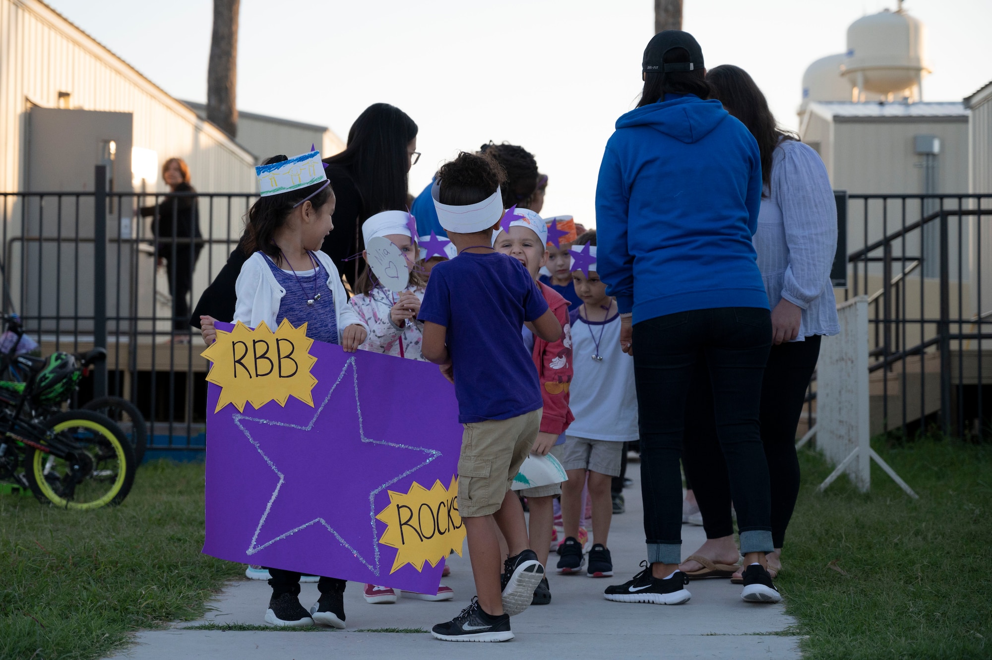 Staﬀ and students from the Roberto Bobby Barrera (RBB) Elementary School prepare to walk the “Purple Parade” held at Laughlin Air Force Base, Texas, Sept. 29, 2022. The “Purple Parade” was held in celebration of RBB Elementary School receiving the Purple Star Award, recognizing the support and commitment the school provides to meeting the unique needs of military-connected students and their families. (U.S. Air Force photo by Airman 1st Class Kailee Reynolds)
