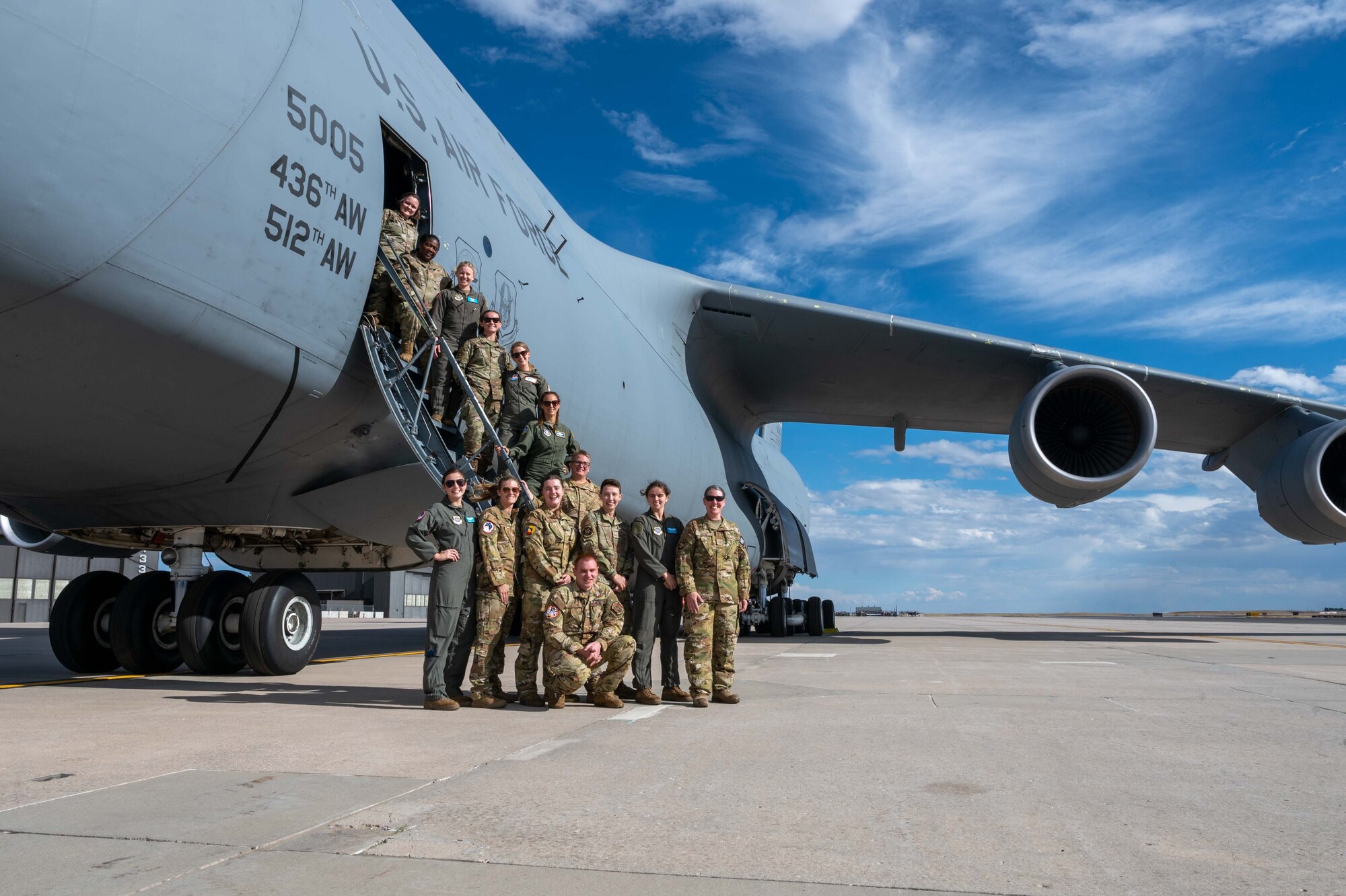 A Team Dover total force aircrew poses for a photo in front of a Dover Air Force Base C-5M Super Galaxy during a visit to Peterson Space Force Base, Colorado, Oct. 1, 2022. During the visit to Peterson SFB, the crew members were able to brief United States Air Force Academy cadets and family members on the Dover AFB mission as well as active duty and reservist career opportunities in the U.S. Air Force. (U.S. Air Force photo by Senior Airman Faith Barron)