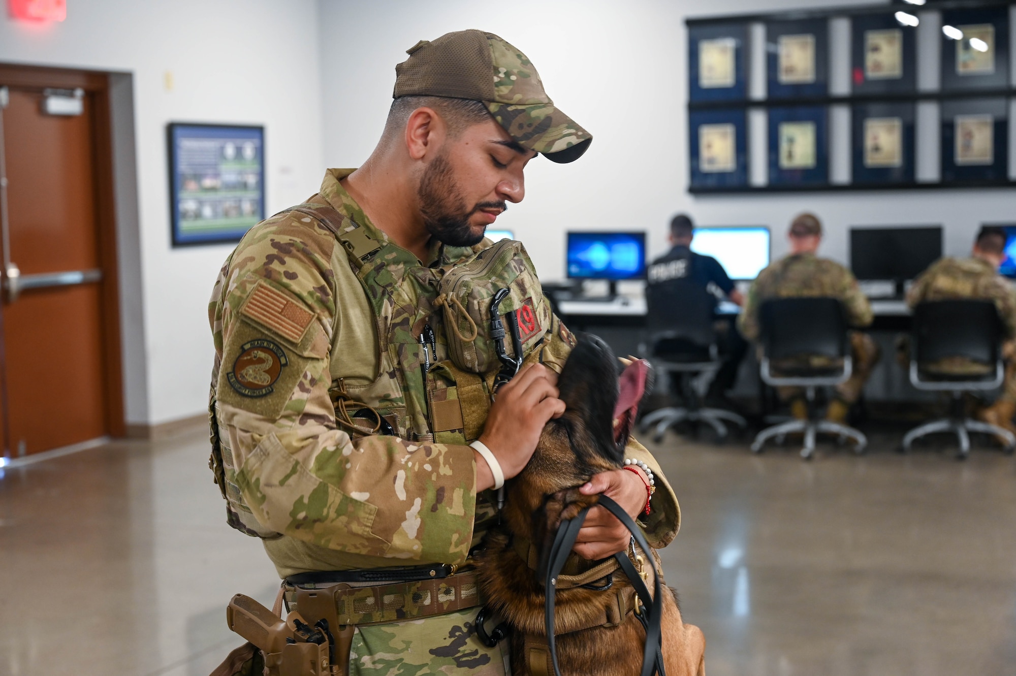 U.S. Air Force Senior Airman Bryan Bolanos, 56th Security Forces Squadron military working dog handler, interacts with his MWD, Edo, Sept. 29, 2022, at Luke Air Force Base, Arizona.