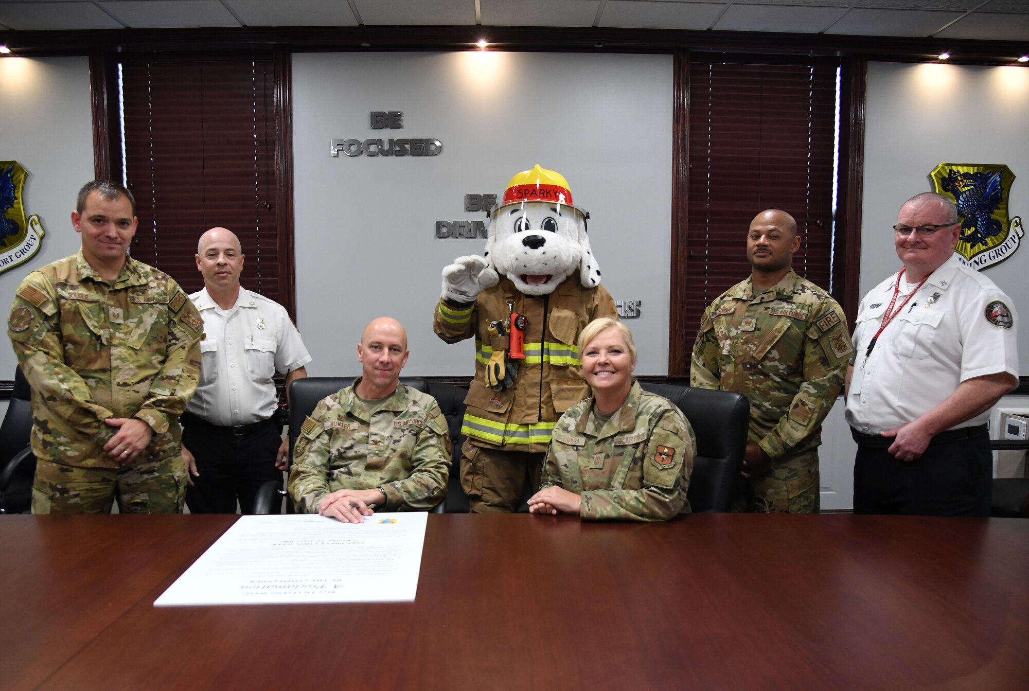 U.S. Air Force Col. William Hunter, 81st Training Wing commander, and Chief Master Sgt. Sarah Esparza, 81st TRW command chief, pose for a photo with members of the Keesler Fire Department after signing the Fire Prevention Week proclamation inside the 81st TRW headquarters building at Keesler Air Force Base, Mississippi, Oct. 4, 2022. The week-long event, Oct. 9-15, includes fire drills, literature hand-outs and visits from Sparky around the base. (U.S. Air Force photo by Kemberly Groue)