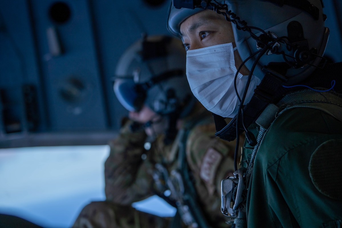 Japan Air Self-Defense Force Tech Sgt. Daichi Kubota, 403rd Tactical Airlift Squadron loadmaster, sits on the ramp of a C-17 Globemaster III during a bilateral training exercise with the 535th Airlift Squadron around the Hawaiian Islands, Sept. 27, 2022. The exercise was held to strengthen partnerships with allies and increase interoperability for future operations with the C-2 and C-17 airframes. (U.S. Air Force photo by Senior Airman Makensie Cooper)
