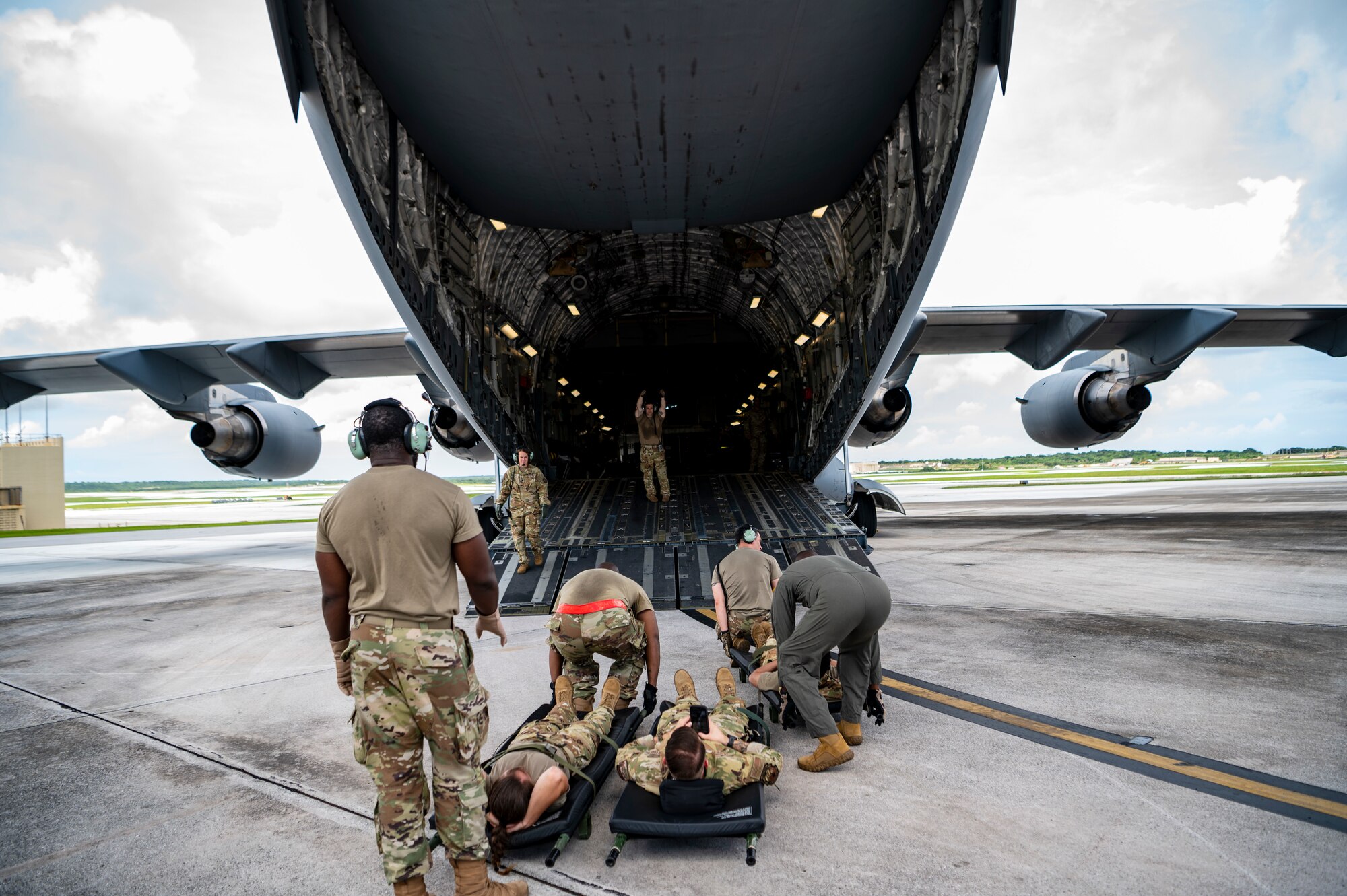 People load simulated patients on a plane