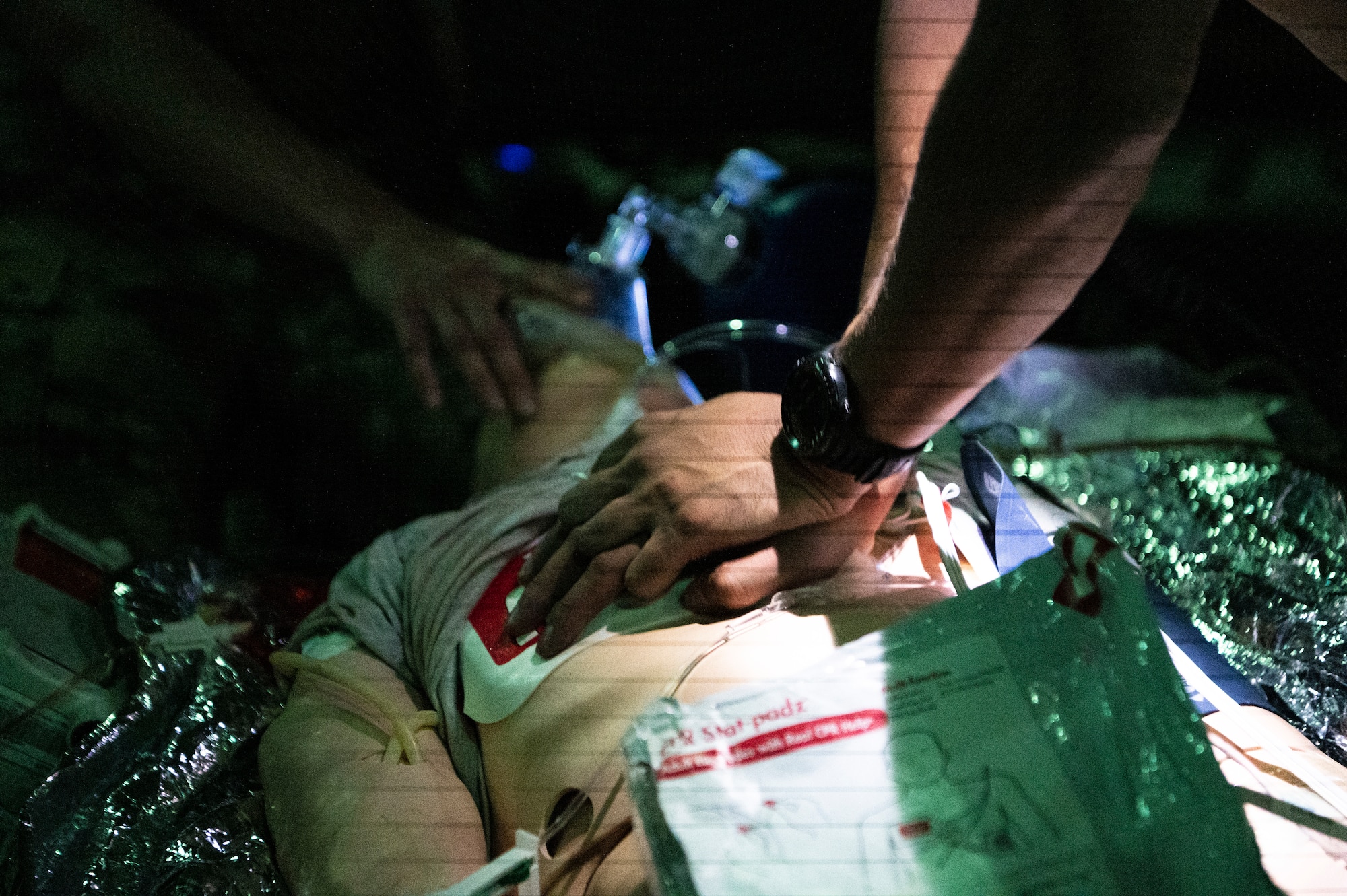 A person performs CPR on a simulated patient