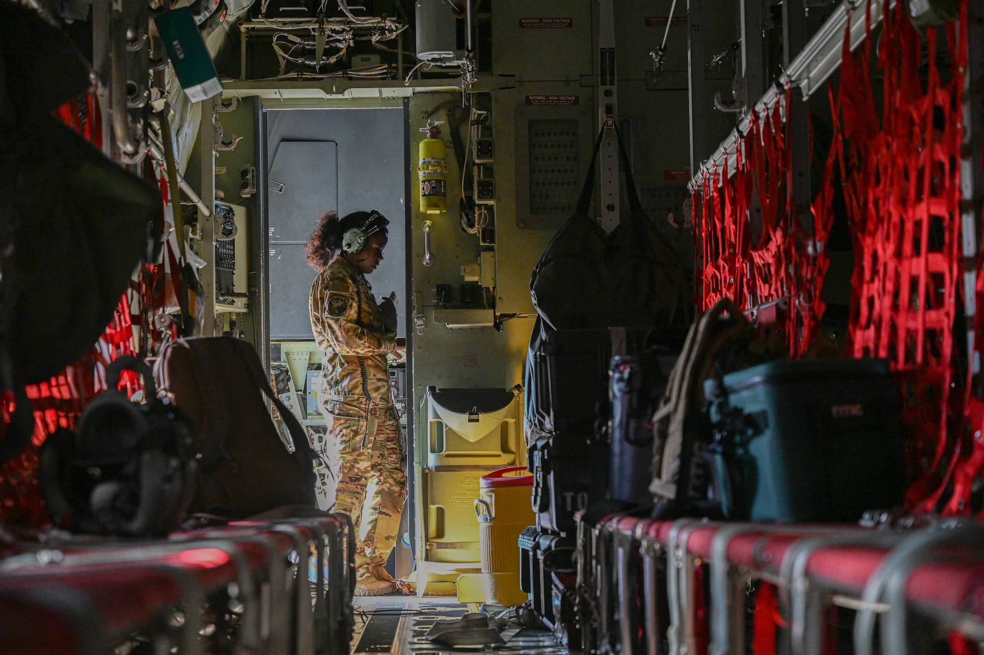 Loadmaster checks cargo weight on a plane.