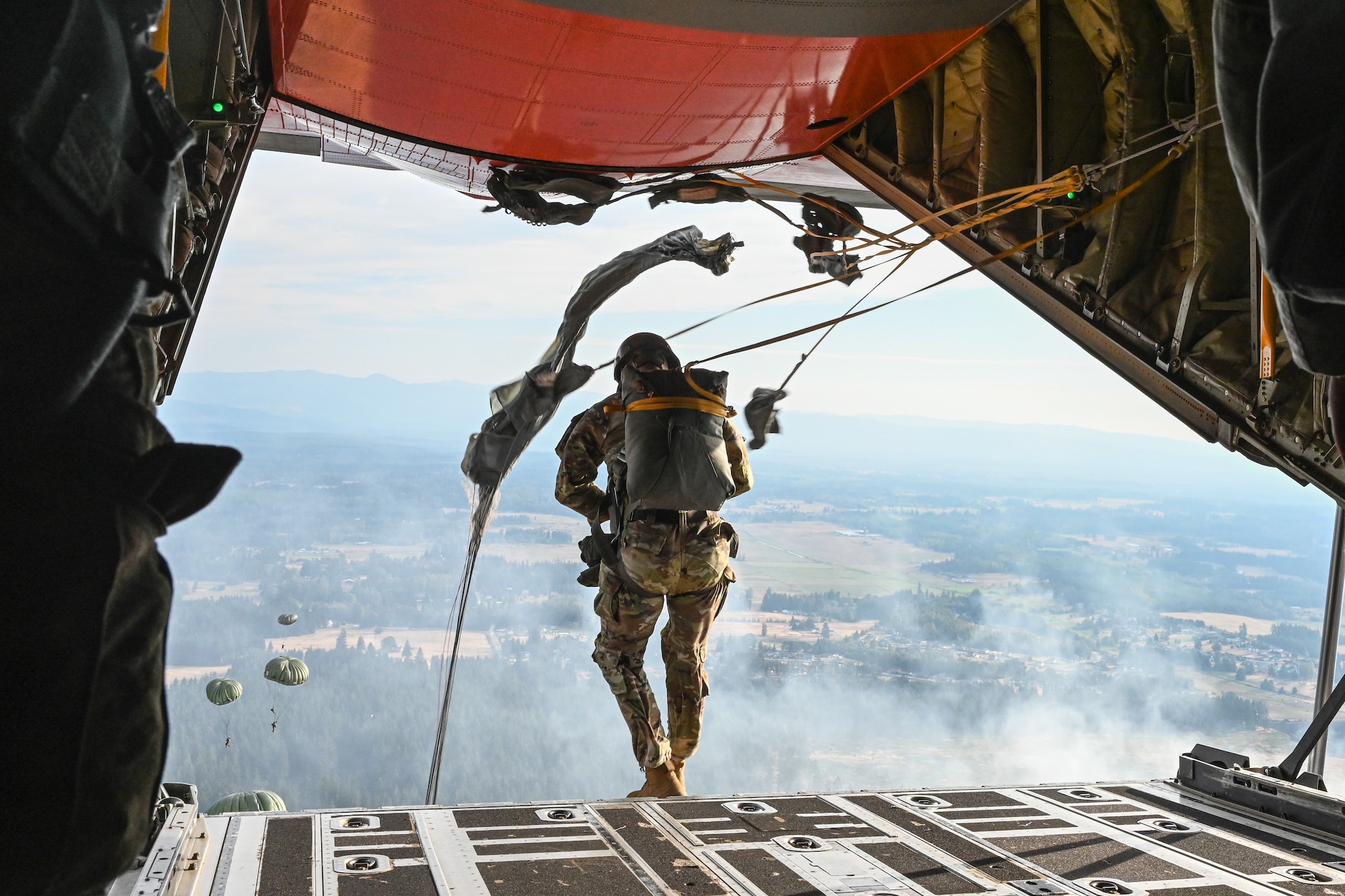 Paratrooper jumps off a plane.