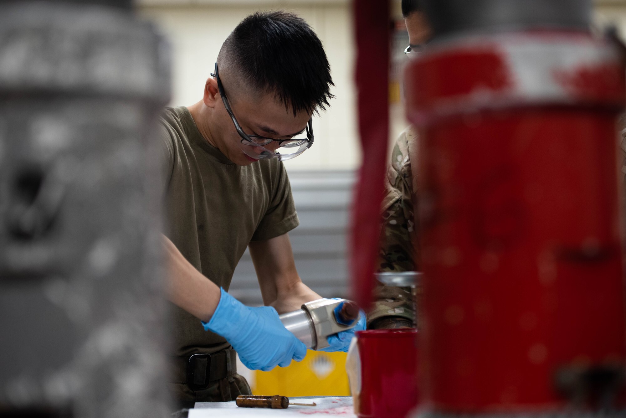An Airman replaces a hydraulic filter.