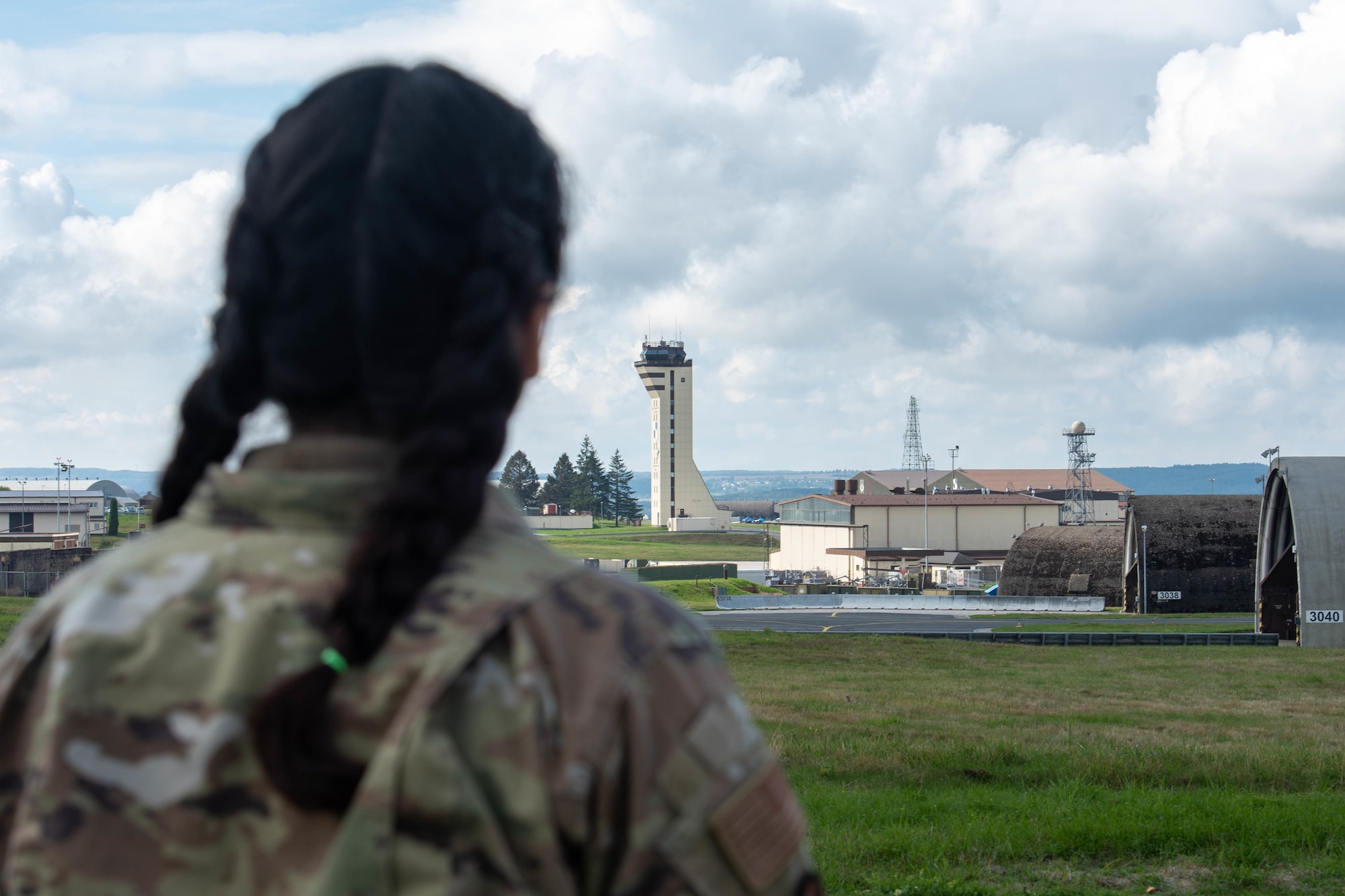An Airman looks at an air traffic control tower.