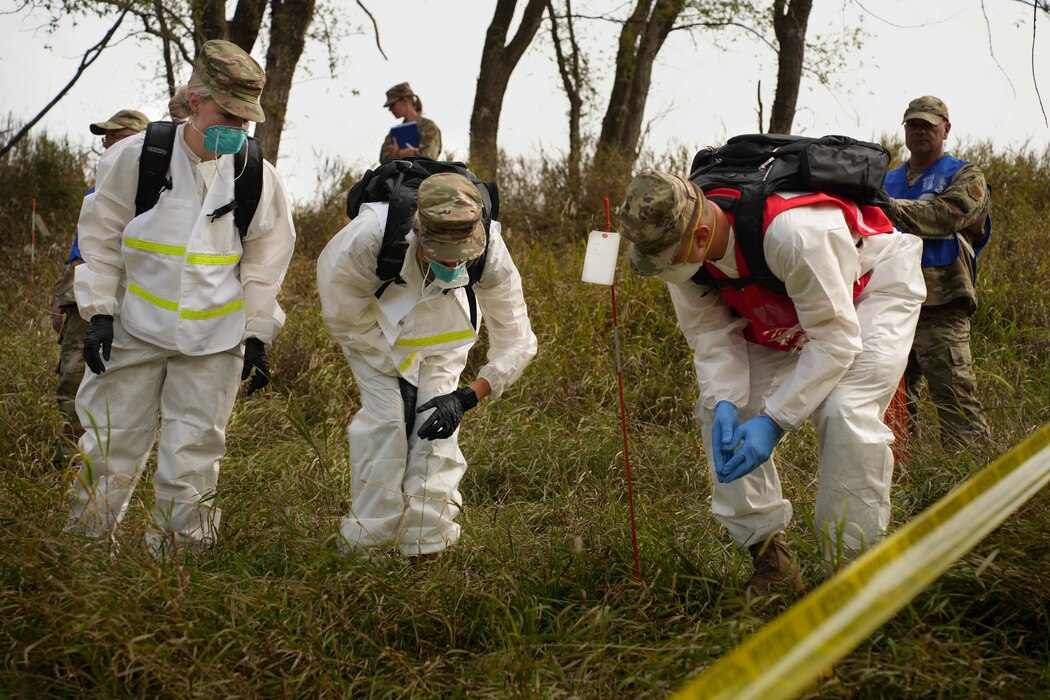 U.S. Air Force Airmen with the 114th Fighter Wing Force Support Squadron examine an artifact located during a simulated search and recovery training mission during October’s Unit Training Assembly at Great Bear Recreation Park, Sioux Falls, South Dakota, Oct. 1, 2022. The squadron traveled to an off-base training site to conduct the hands-on training in an effort to execute large-scale readiness exercises as a means to stay mission ready in order to execute real-world missions at a moments notice. (U.S. Air National Guard photo by Staff Sgt. Jorrie Hart)