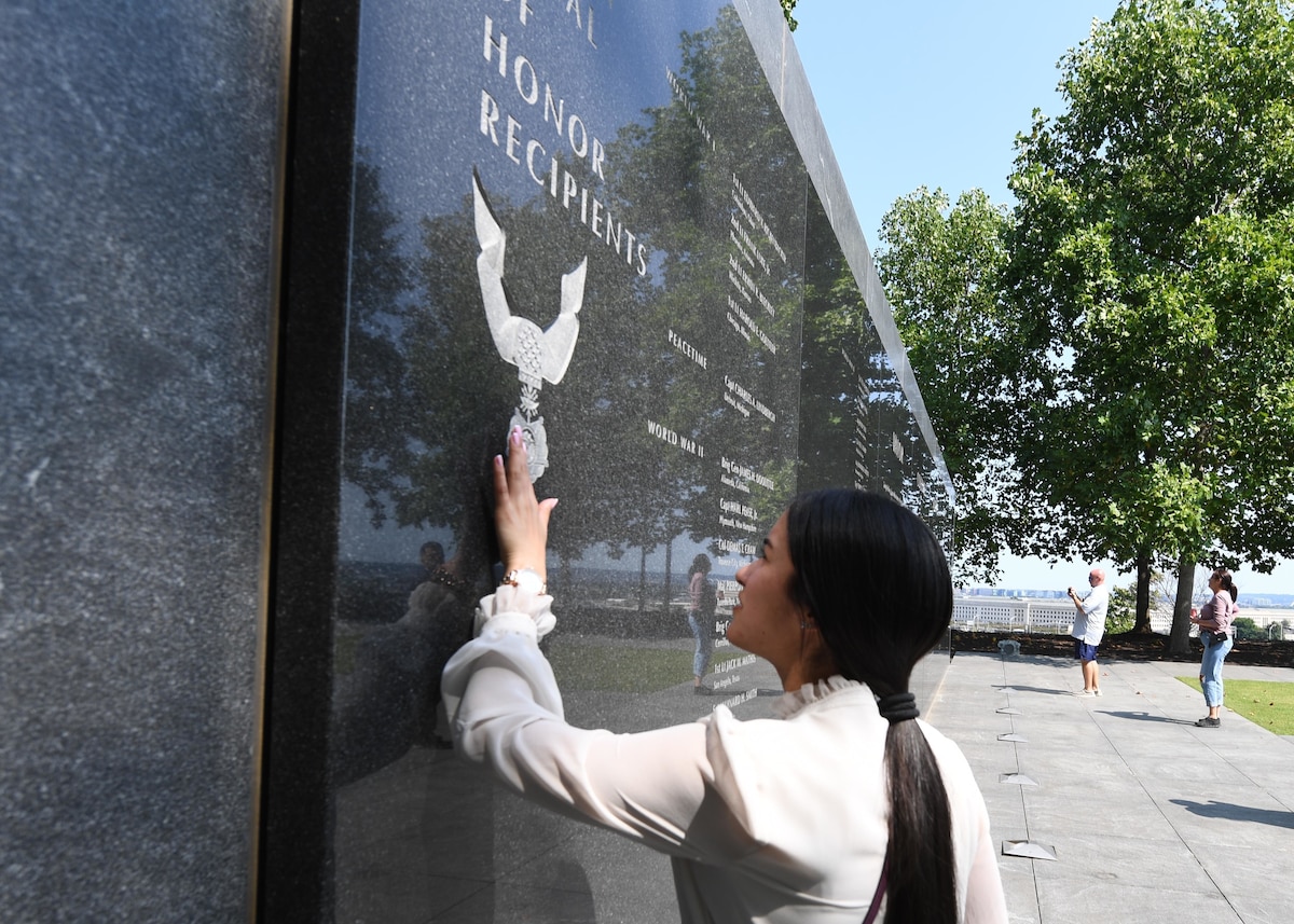 Senior Airman Monica A. Figueroa Santos, 2022 Outstanding Airman of the Year representing Air Force Global Strike Command, looks at a memorial wall at the Air Force Memorial in Arlington, Va., Sept. 18, 2022. Santos, along with the other 12 Outstanding Airmen of the Year, attended a National Capital Region tour where they visited different historical and national landmarks across Virginia, Maryland and Washington, D.C. (U.S. Air Force photo by Staff Sgt. Nick Z. Erwin)