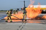 Firefighters with the 167th Civil Engineering Squadron practice their extinguishing techniques with the West Virginia University Fire Service Extension’s mobile aircraft fire simulator during an emergency response exercise at the 167th Airlift Wing, Shepherd Field, Martinsburg, West Virginia, Sept. 16, 2022. The simulator provided a realistic training environment for the exercise.