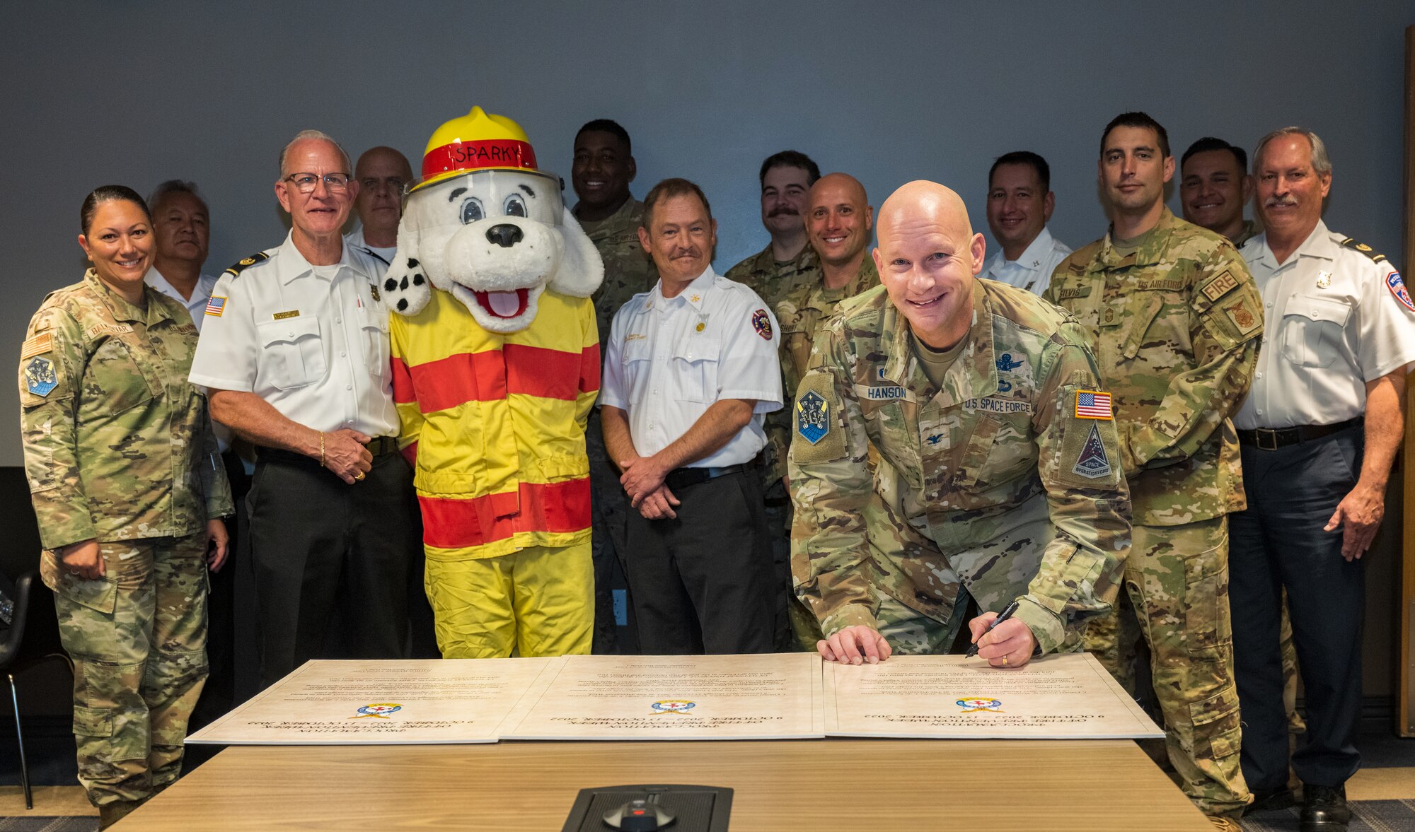 SBD 1 Commander signs Fire Safety Week proclamation with other Civil Engineering members present