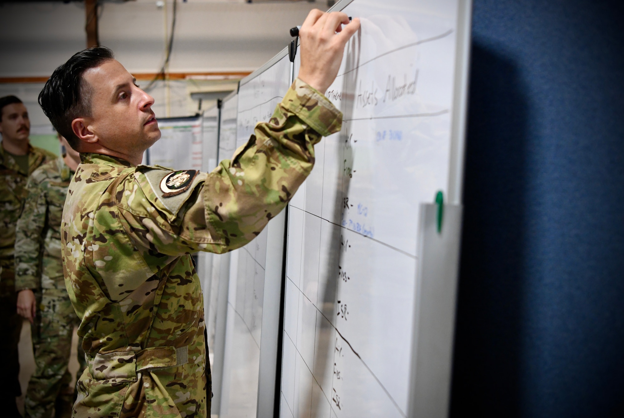 A Special Operation Task Group (SOTG) Air Commando, prepares a whiteboard for a mission planning meeting during a certification exercise (CERTEX) Aug. 9, 2022 at Hurlburt Field, Florida. The SOTG is made of several Special Operations Task Units (SOTUs) that have achieved their peak mission readiness and are ready to deploy to a Joint Task Unit together, made of special operations forces from every branch of the U.S. military.