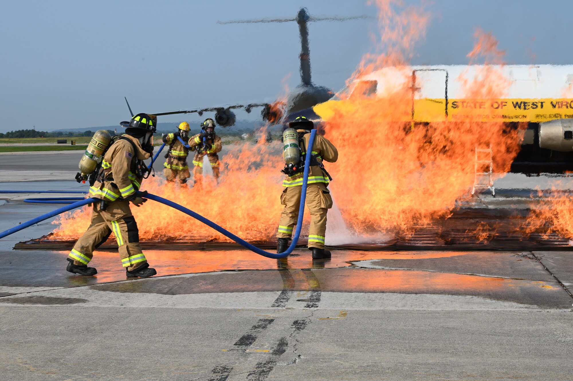 Firefighters with the 167th Civil Engineering Squadron practice their extinguishing techniques with the West Virginia University Fire Service Extension’s mobile aircraft fire simulator during an emergency response exercise at the 167th Airlift Wing, Shepherd Field, Martinsburg, West Virginia, Sept. 16, 2022. The simulator provided a realistic training environment for the exercise.