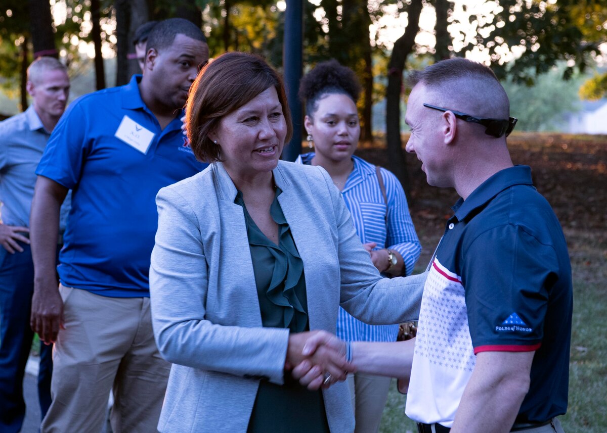Chief Master Sgt. of the Air Force JoAnne S. Bass greets one of the attendees at the 12 Outstanding Airmen of the Year social at Andrews Air Force Base, Md., Sept. 18, 2022. Bass hosted a social icebreaker to introduce the 2022 12 Outstanding Airmen of the Year to different senior leaders and to recognize each of the Airmen for their accomplishments. (U.S. Air Force photo by Staff Sgt. Nick Z. Erwin)