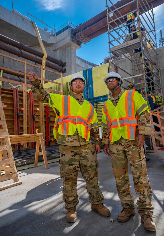 U.S. Air Force Tech. Sgt. Justin Rico, 633d Civil Engineer Squadron Fire Department station chief, points to examine elements of the Hampton Roads Bridge-Tunnel at the South Island excavation site, Hampton, Virginia, Sept. 25, 2022.