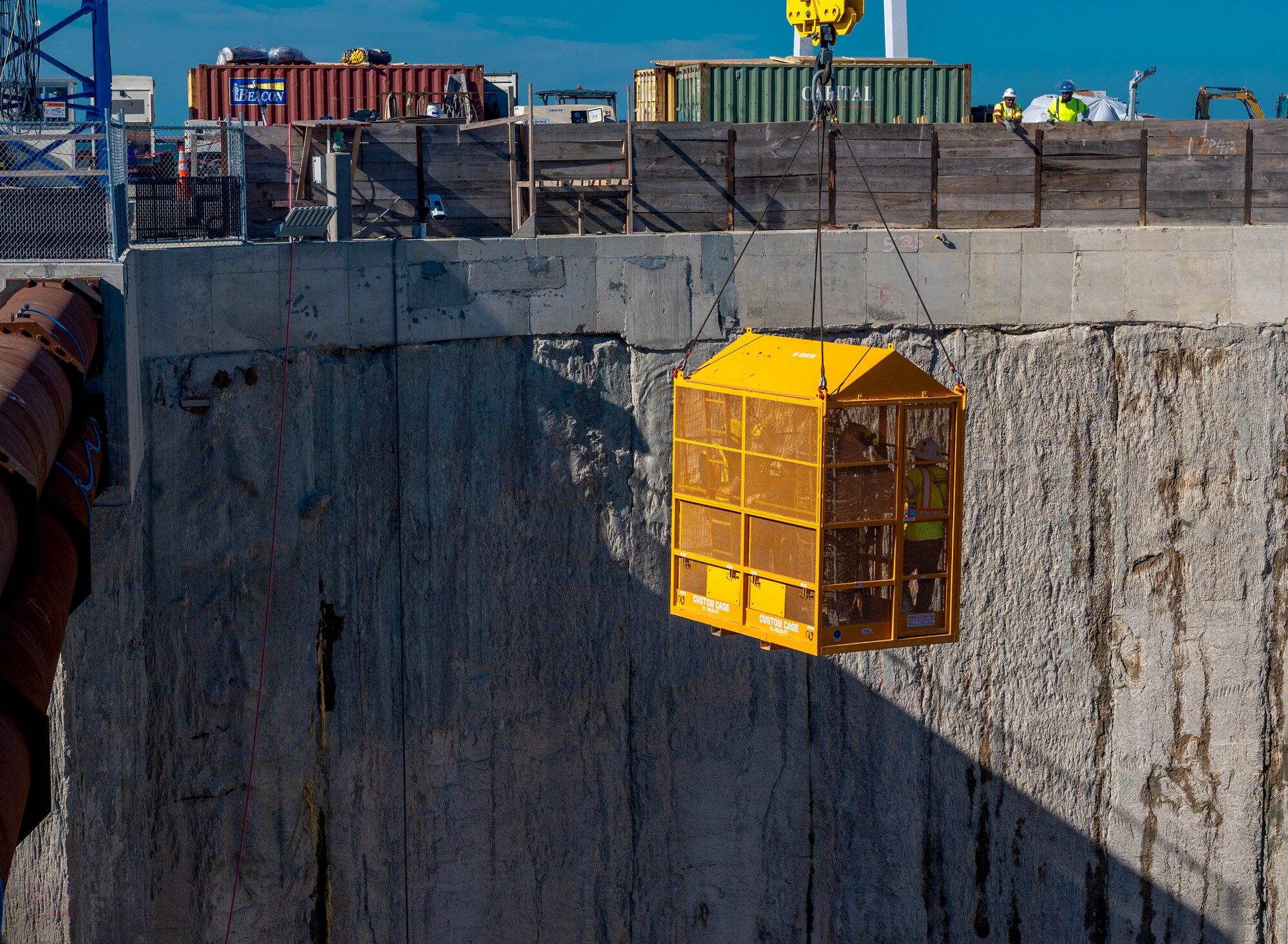 Members from the Hampton, Norfolk and Langley Air Force Base fire rescue teams descend into a pit from the Hampton Roads-Bridge Tunnel at the South Island excavation site, Hampton, Virginia, Sept. 25, 2022.