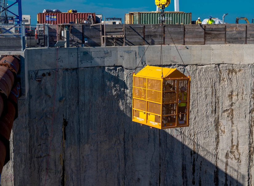 Members from the Hampton, Norfolk and Langley Air Force Base fire rescue teams descend into a pit from the Hampton Roads-Bridge Tunnel at the South Island excavation site, Hampton, Virginia, Sept. 25, 2022.