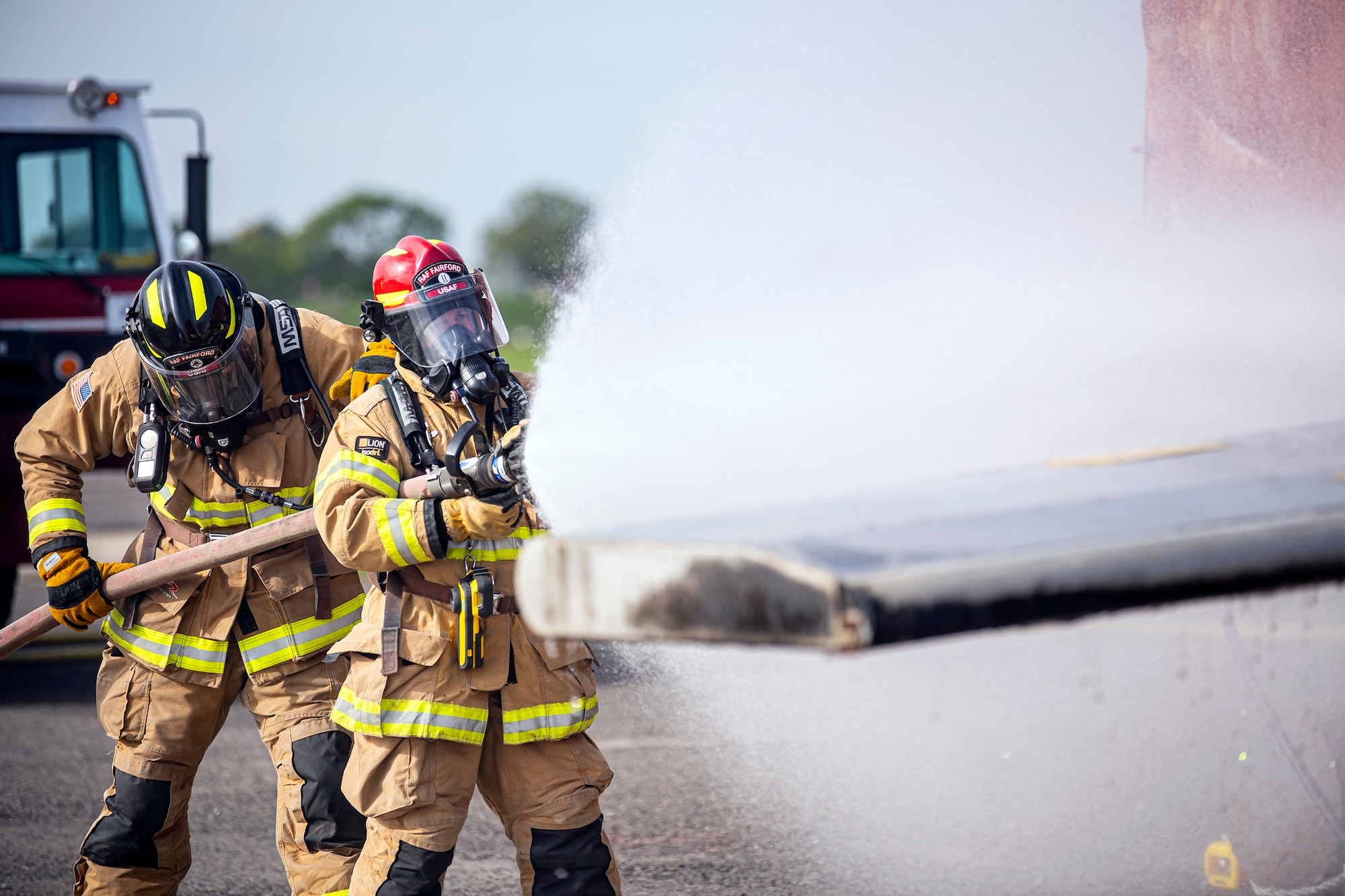 Firefighters from the 422d Fire Emergency Services extinguish an aircraft fire during a live-fire training exercise at RAF Fairford, England, Oct. 3, 2022. Firefighters from the 422d FES are required to complete live-fire training bi-annually to test their overall readiness and ability to properly extinguish an aircraft fire. (U.S. Air Force photo by Staff Sgt. Eugene Oliver)