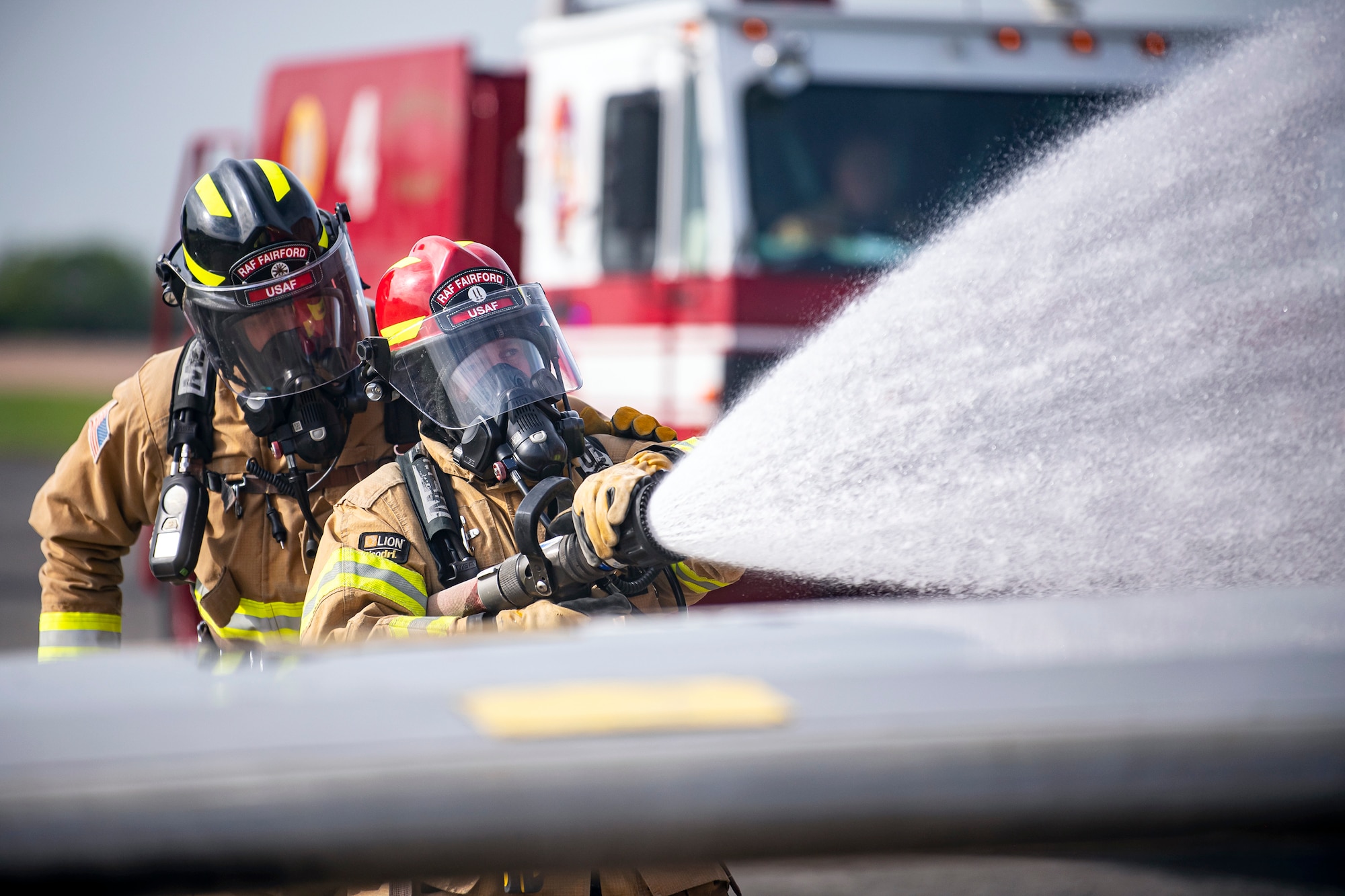 Firefighters from the 422d Fire Emergency Services extinguish an aircraft fire during a live-fire training exercise at RAF Fairford, England, Oct. 3, 2022. Firefighters from the 422d FES are required to complete live-fire training bi-annually to test their overall readiness and ability to properly extinguish an aircraft fire. (U.S. Air Force photo by Staff Sgt. Eugene Oliver)