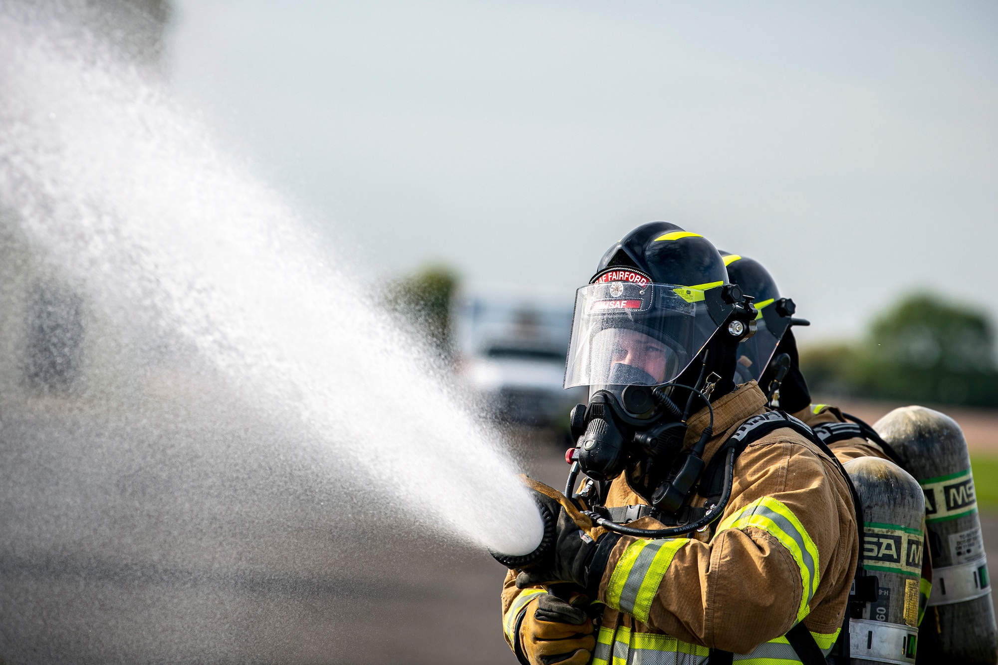 Firefighters from the 422d Fire Emergency Services extinguish an aircraft fire during a live-fire training exercise at RAF Fairford, England, Oct. 3, 2022. Firefighters from the 422d FES are required to complete live-fire training bi-annually to test their overall readiness and ability to properly extinguish an aircraft fire. (U.S. Air Force photo by Staff Sgt. Eugene Oliver)