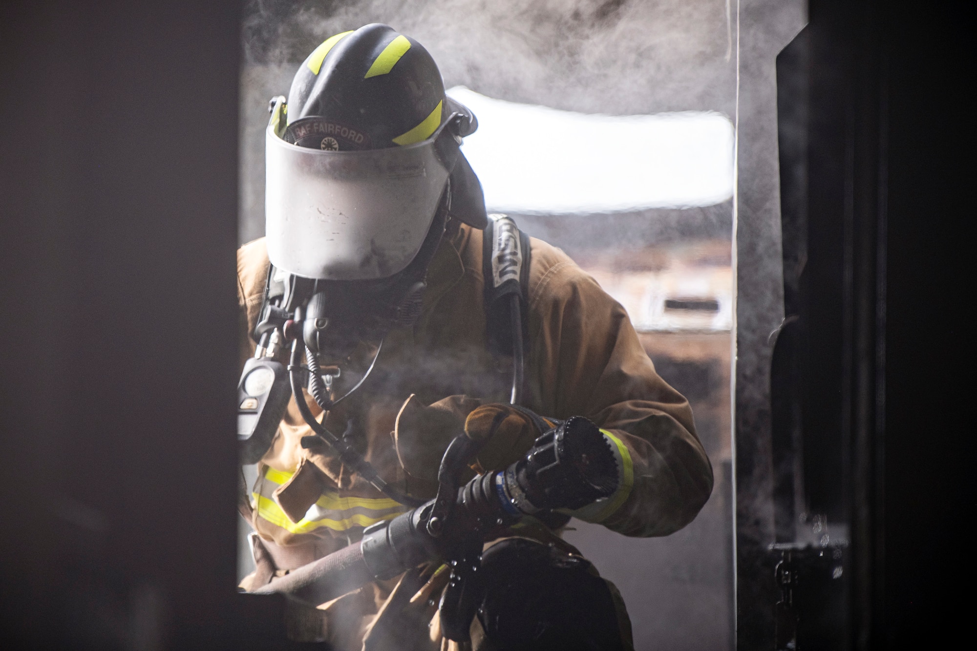 A firefighter from the 422d Fire Emergency Services extinguishes an aircraft fire during a live-fire training exercise at RAF Fairford, England, Oct. 3, 2022. Firefighters from the 422d FES are required to complete live-fire training bi-annually to test their overall readiness and ability to properly extinguish an aircraft fire. (U.S. Air Force photo by Staff Sgt. Eugene Oliver)