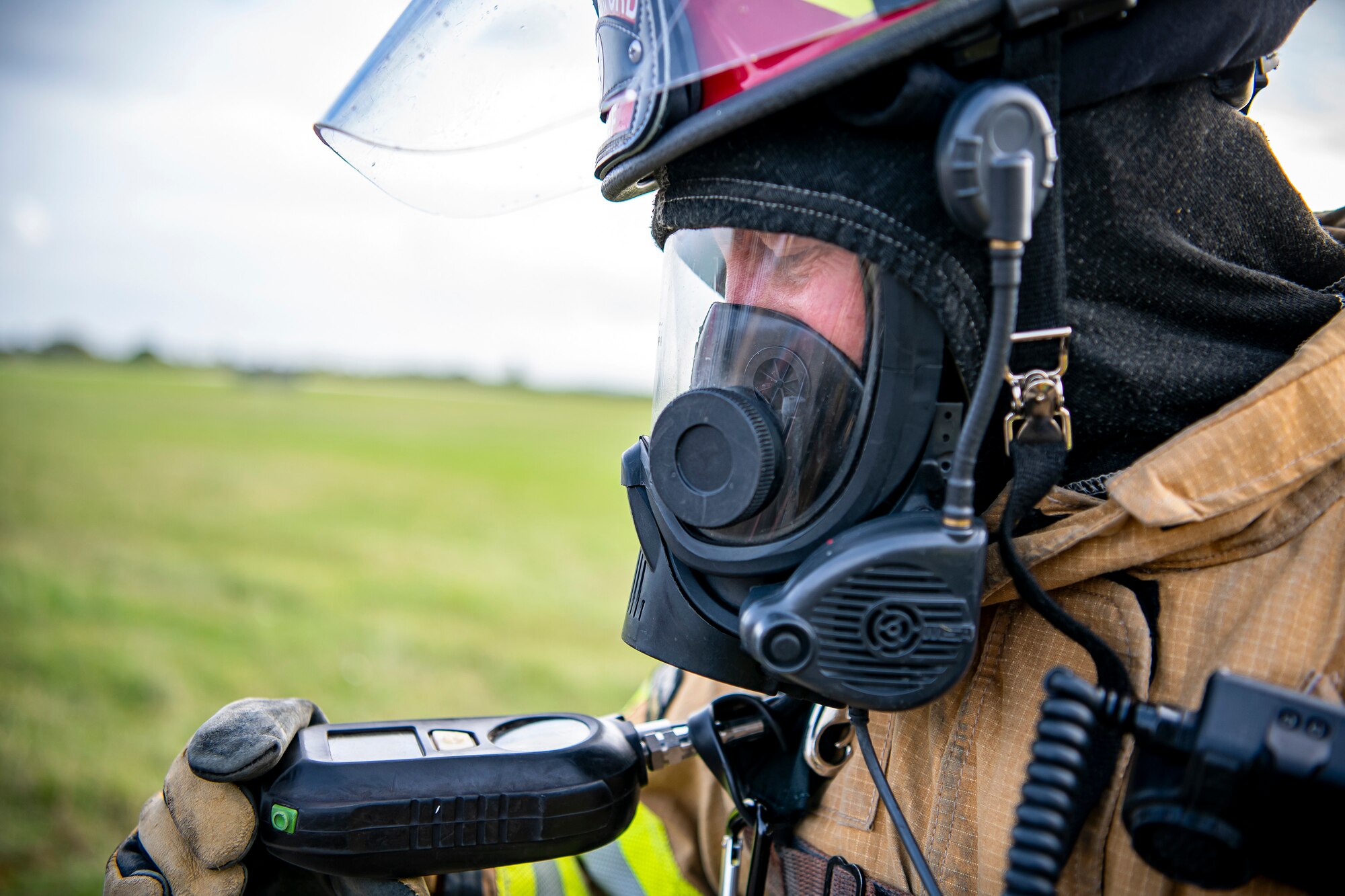 A firefighter from the 422d Fire Emergency Services, monitors his oxygen levels during a live-fire training exercise at RAF Fairford, England, Oct. 3, 2022. Firefighters from the 422d FES, are required to complete live-fire training bi-annualy to test thief overall readiness and ability to properly extinguish an aircraft fire. (U.S. Air Force photo by Staff Sgt. Eugene Oliver)