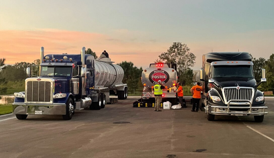 three large tank trucks parked