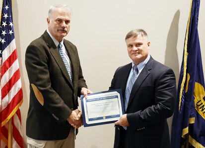 IMAGE: Naval Surface Warfare Center Dahlgren Division Command Review and Investigations (CR&I) Director Robert Longworth accepts the fiscal 2021 Naval Sea Systems Command (NAVSEA) Inspector General’s (IG) CR&I Office Spotlight Award Small Office of the Year presented by NAVSEA IG Carl J. Adams, Jr., on behalf of the whole team during the annual NAVSEA Training Symposium held in Pensacola, Florida Sept. 19.