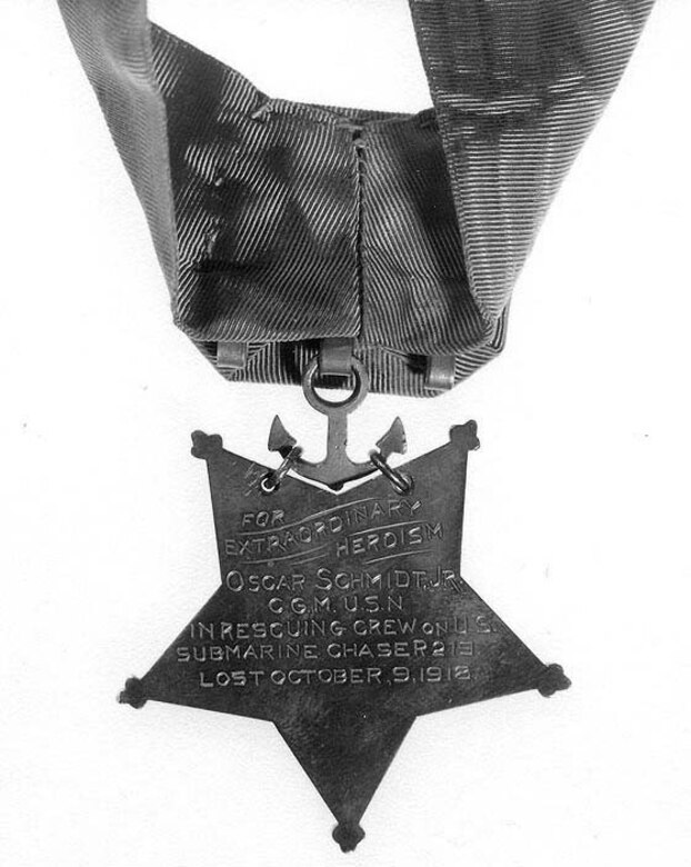 The back of a star-shaped medal shows an inscription.